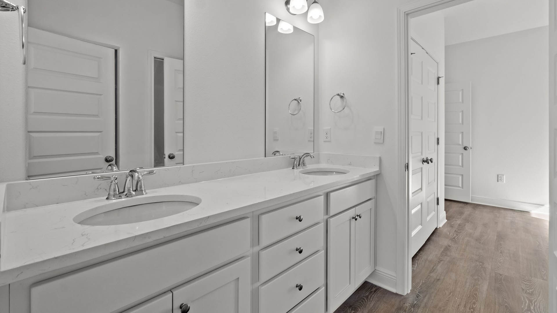 Primary bathroom features a double vanity sink with beautiful quartz countertop and lower cabinetry and storage drawers
