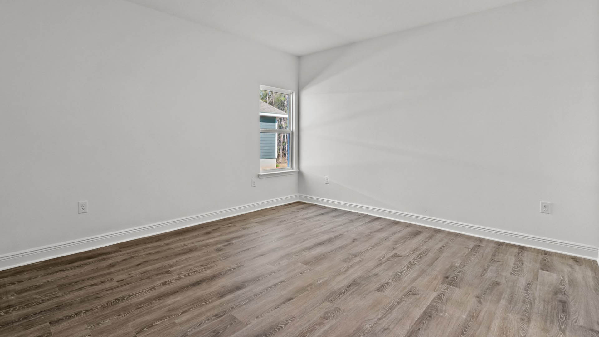 The spacious bedroom four is located off foyer with a hall leading to laundry room and study