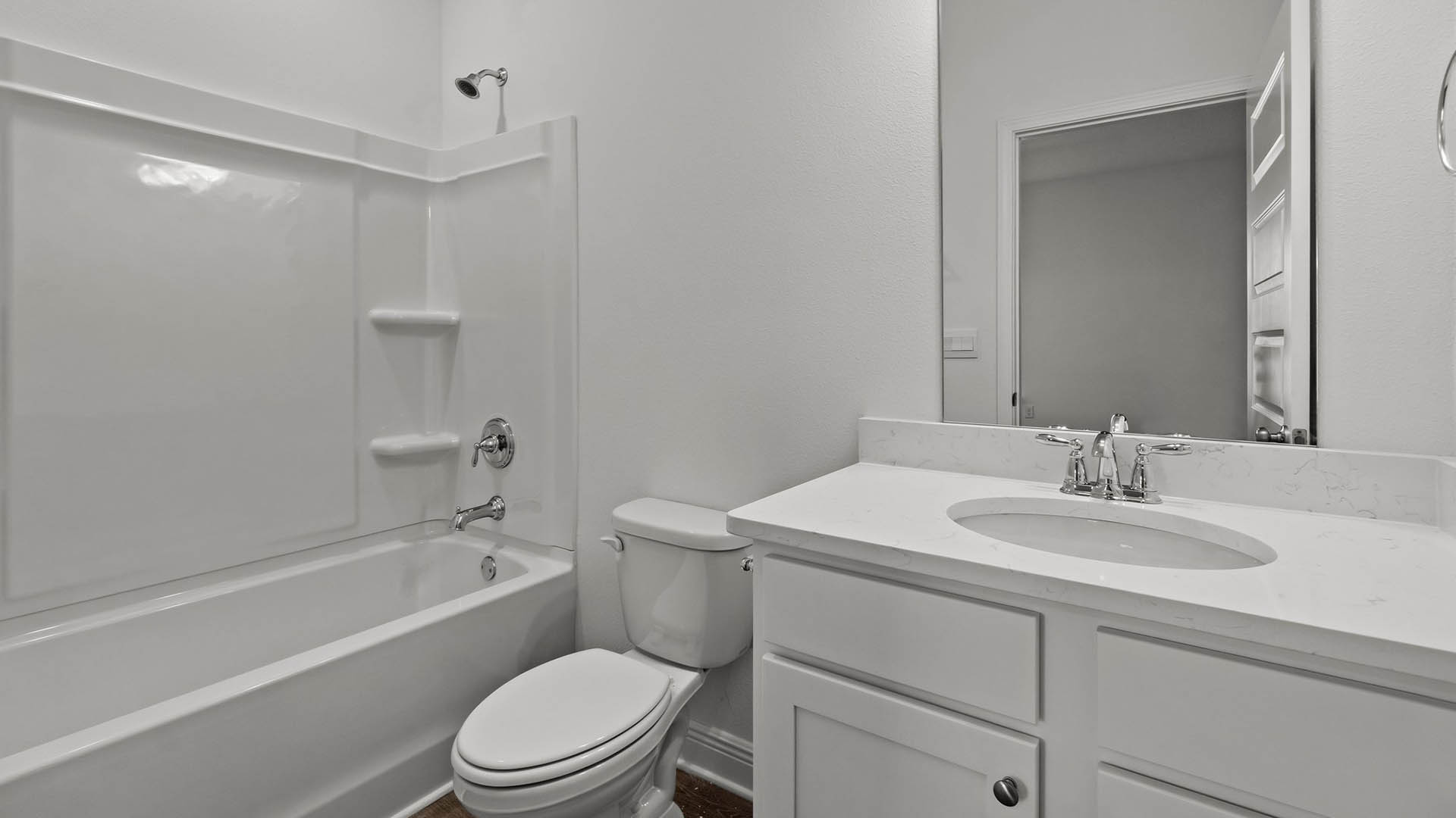 Shared bathroom between bedrooms two and three with shower tub combination and EVP flooring as well as quartz countertop