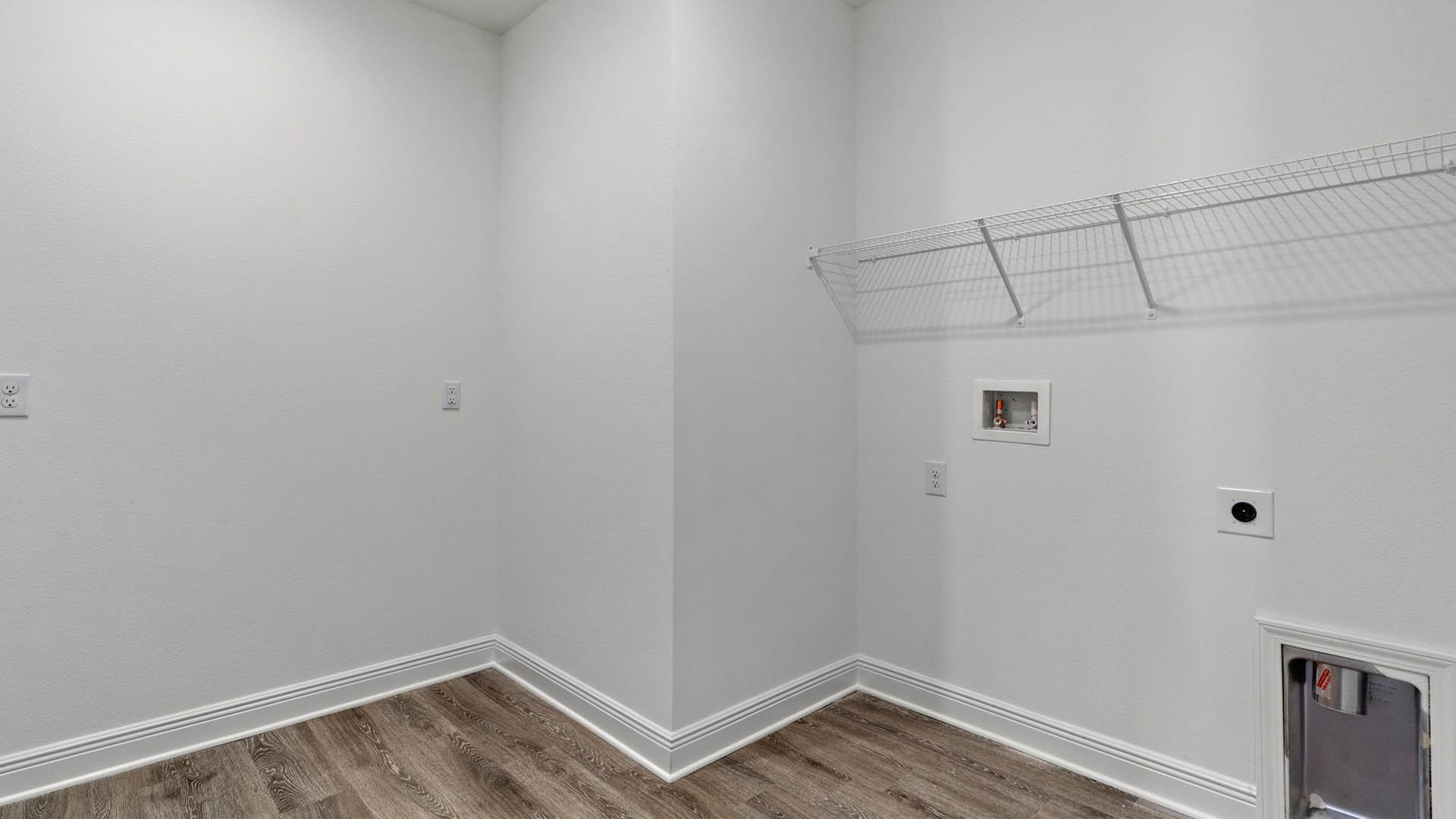 The Camden has a large laundry room with shelf and space for a full size washer and dryer