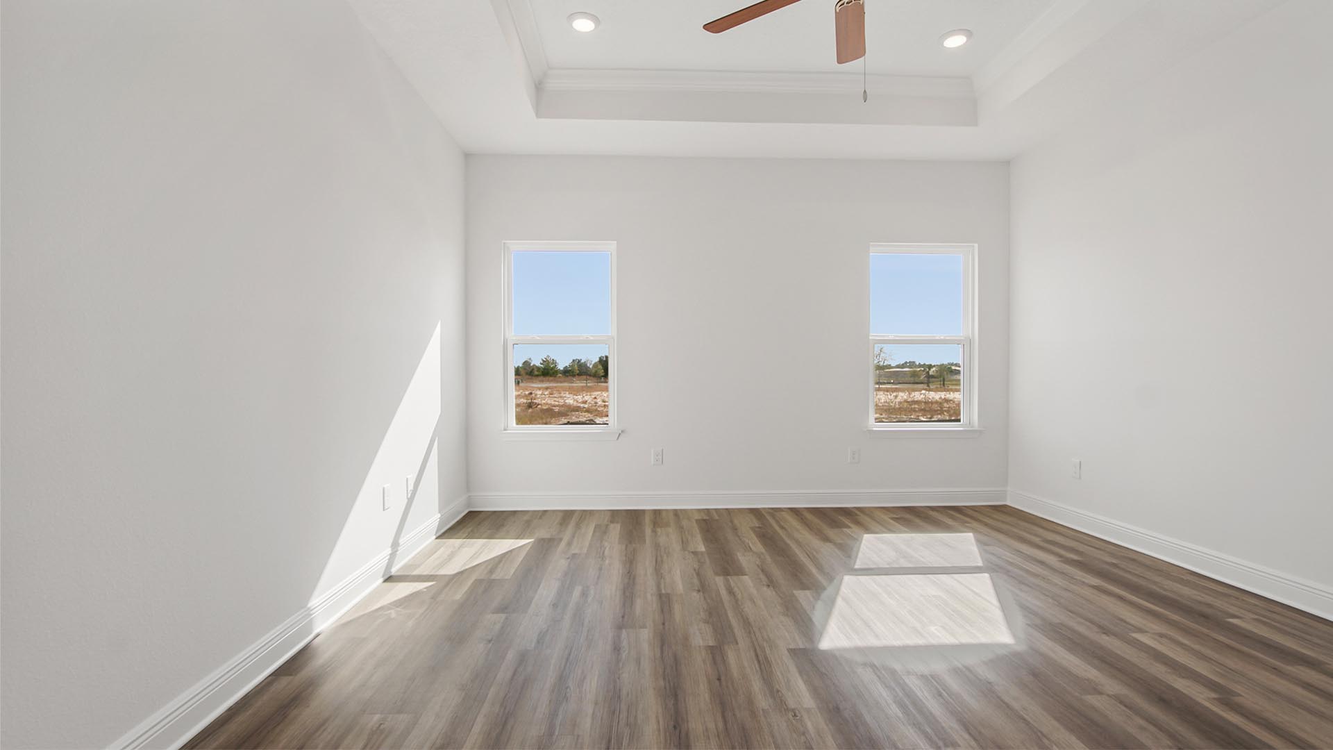 The Primary bedroom features trey ceilings and EVP flooring