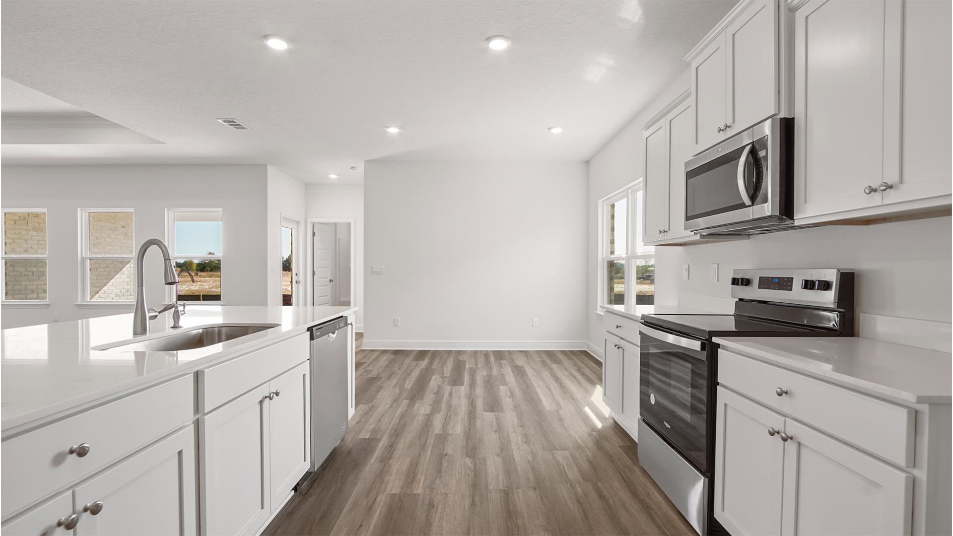 The kitchen is complete with a stainless steel appliance package including a stove microwave and dishwasher