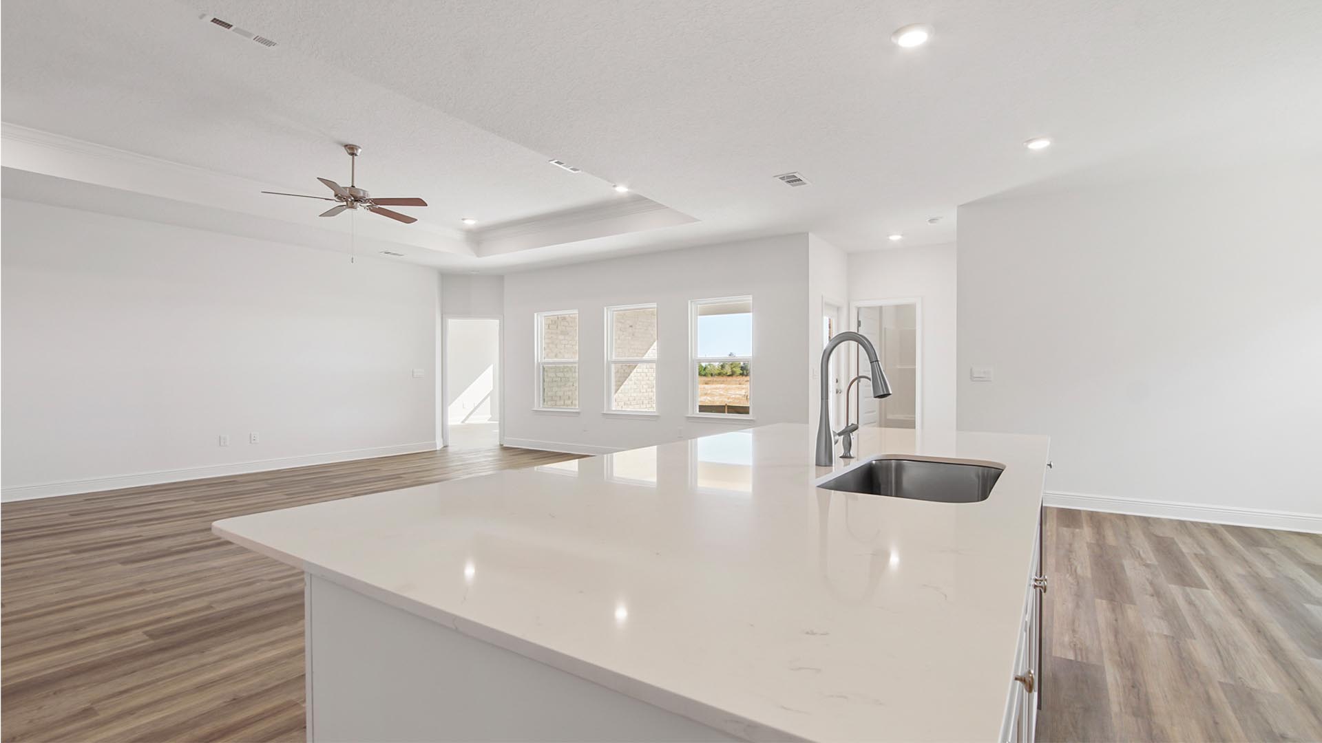 A large center island allows for easy meal prep and clean up and features a sink and dishwasher