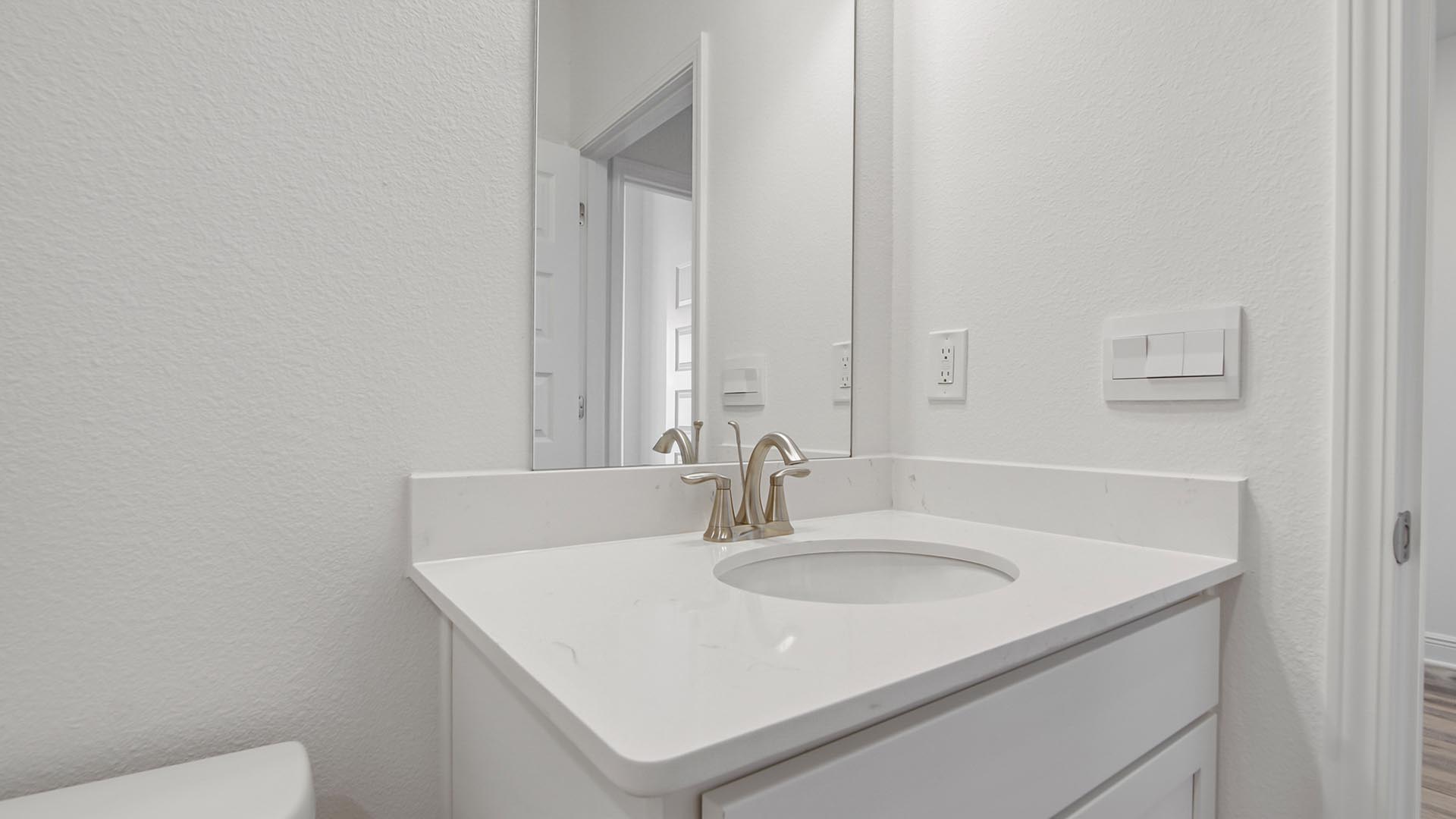 The vanity is finished with elegant quartz countertops