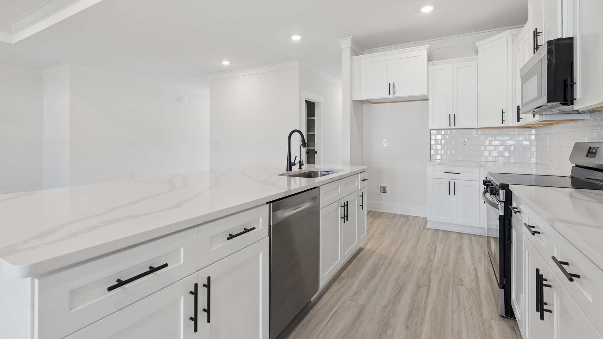 The kitchen appliances include a stove microwave and dishwasher