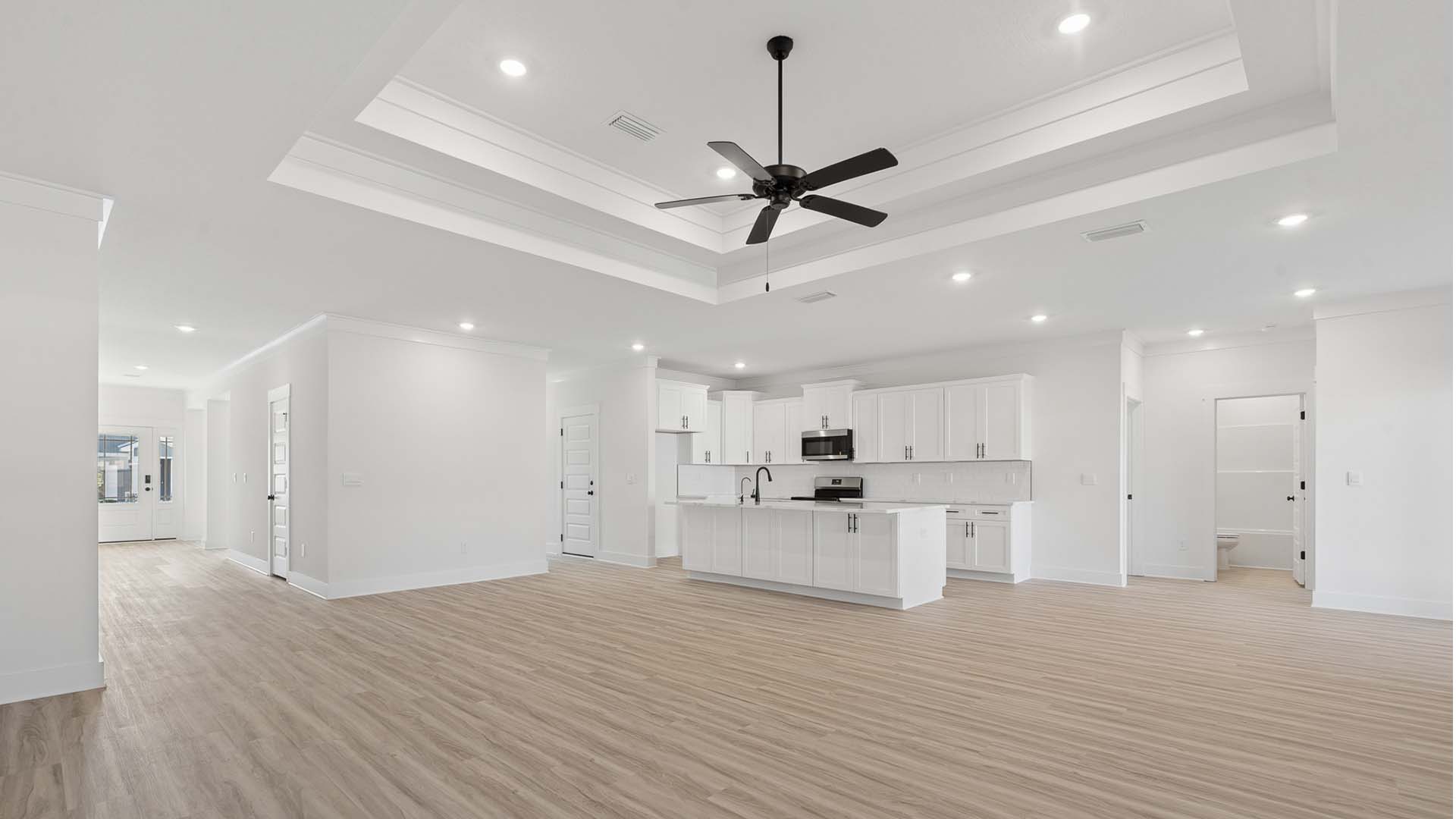 The expansive living room has the tray ceilings that add to height to the space