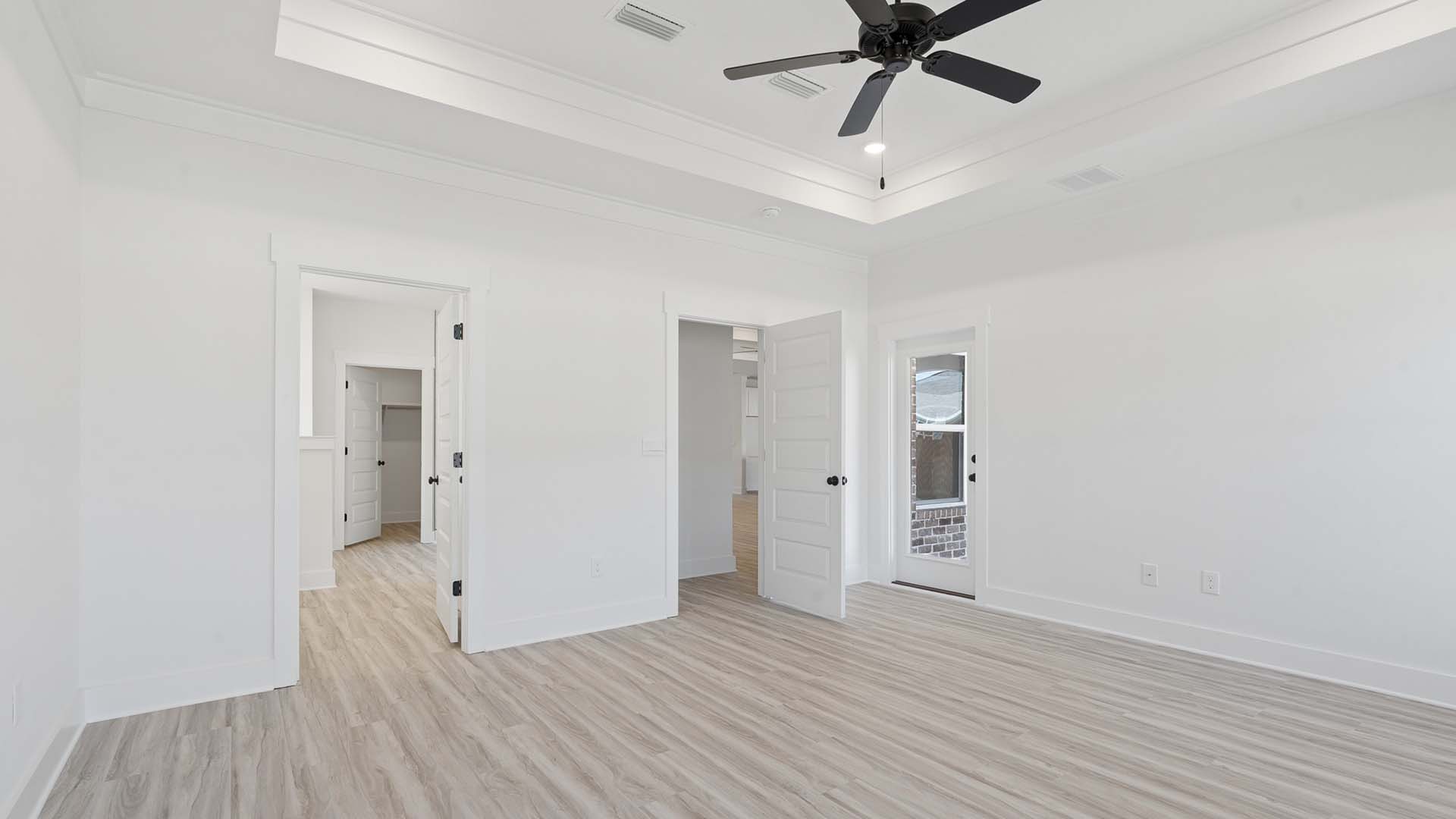 The primary bedroom has tray ceilings and a private ensuite bathroom