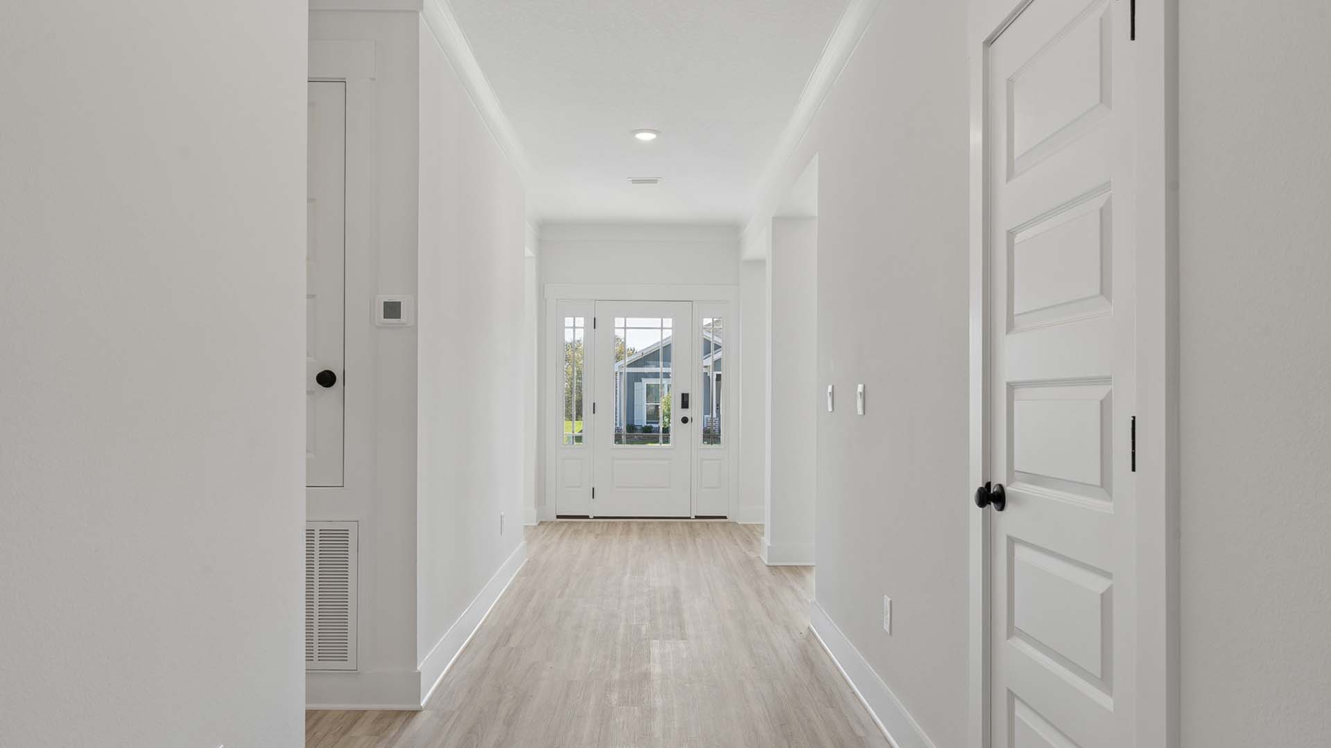 From the living area the entry hall back to the front door there are two bedrooms