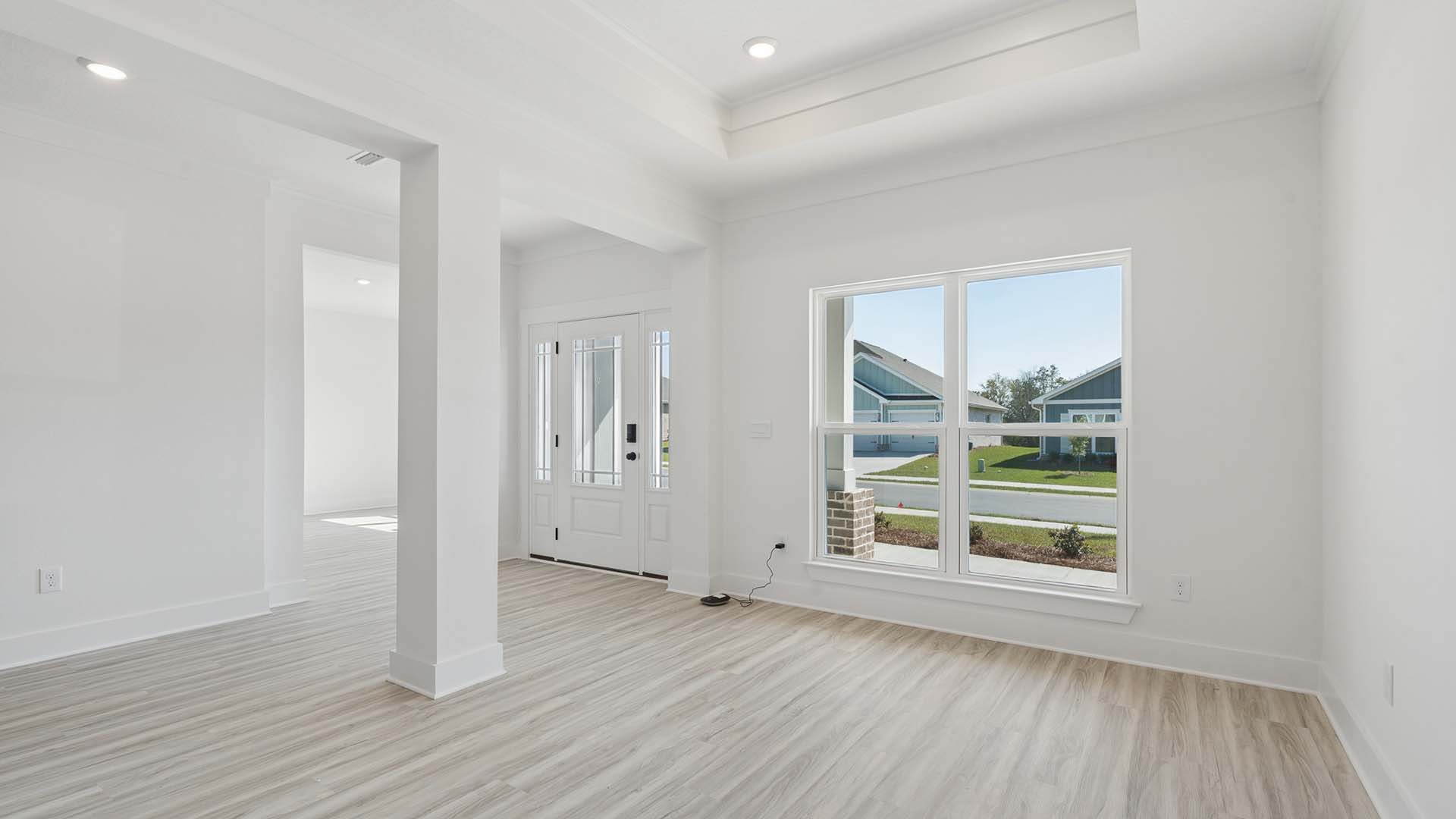 The dining area has a large picture window enveloping the room in natural light