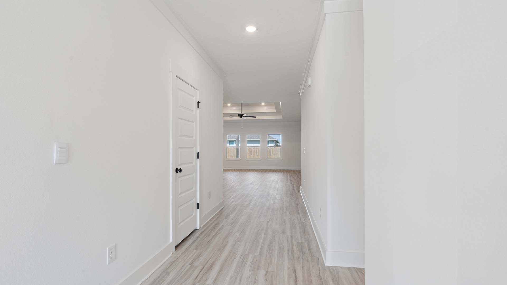 The light filled foyer and hallway leading to the living area