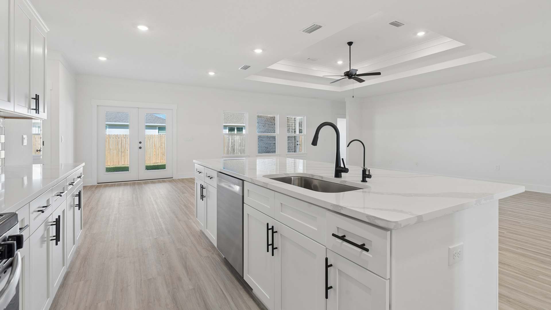 The kitchen island holds the dishwasher and single basin sink