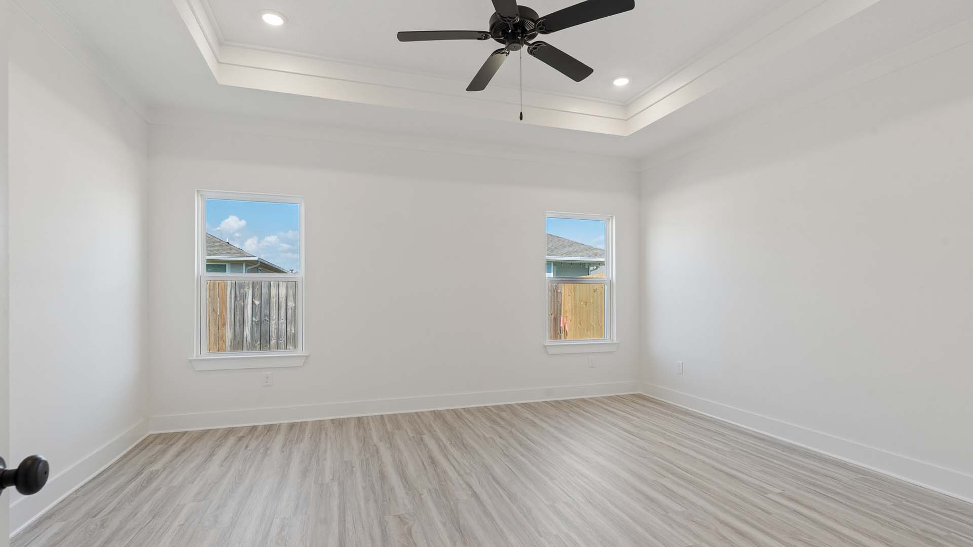 The primary bedroom is off the kitchen and has trey ceiling
