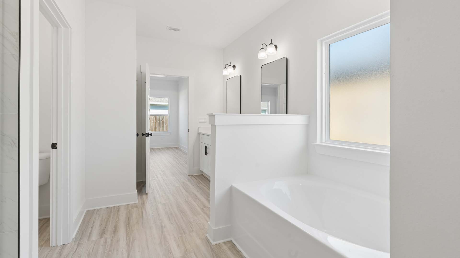 The primary bath has a soak tub and separate shower