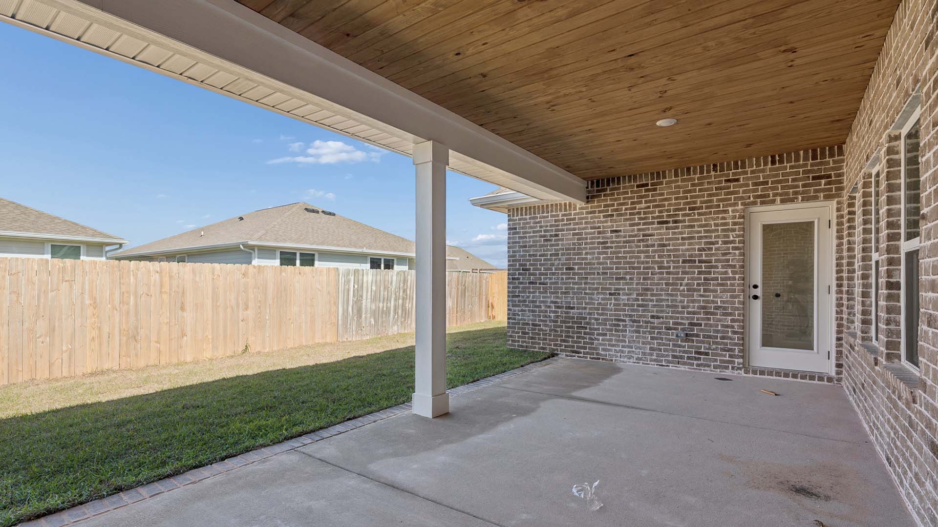 The back of the home has a covered patio