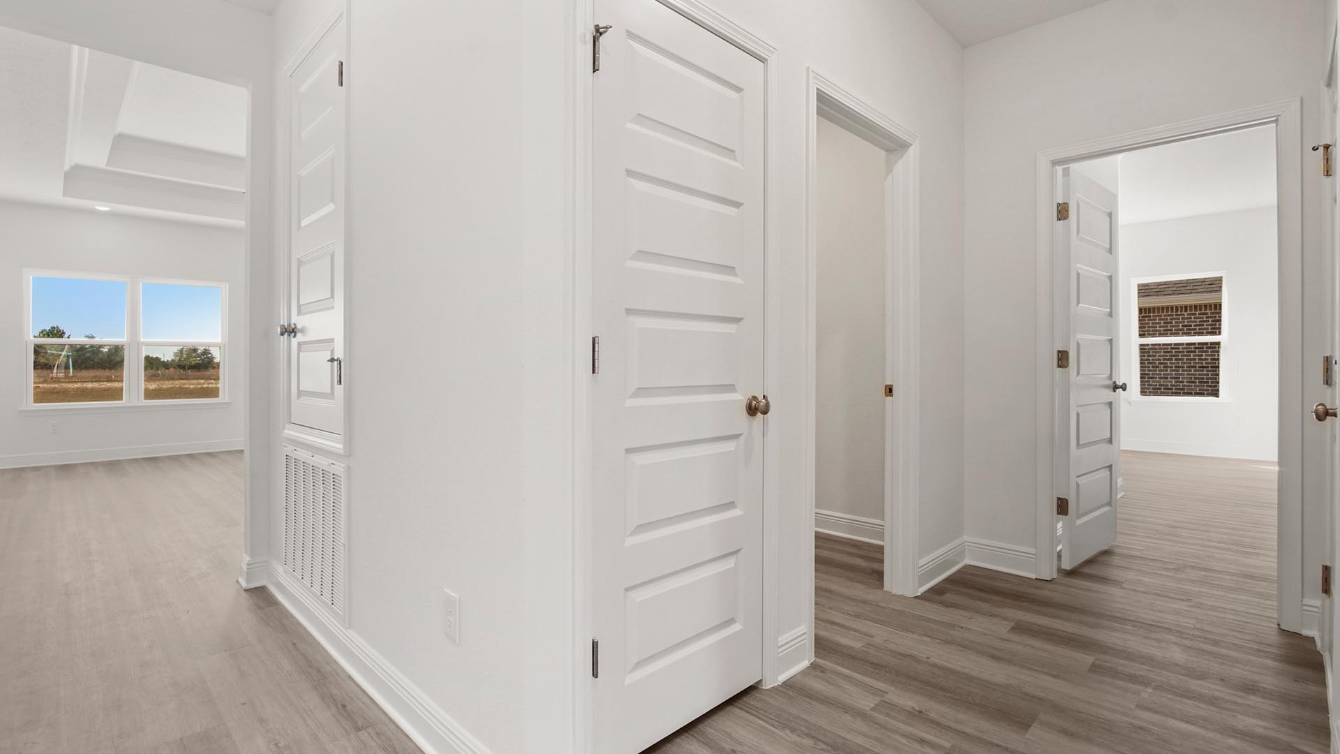 There is a dedicated hall for bedroom four that has the laundry room and access to the garage