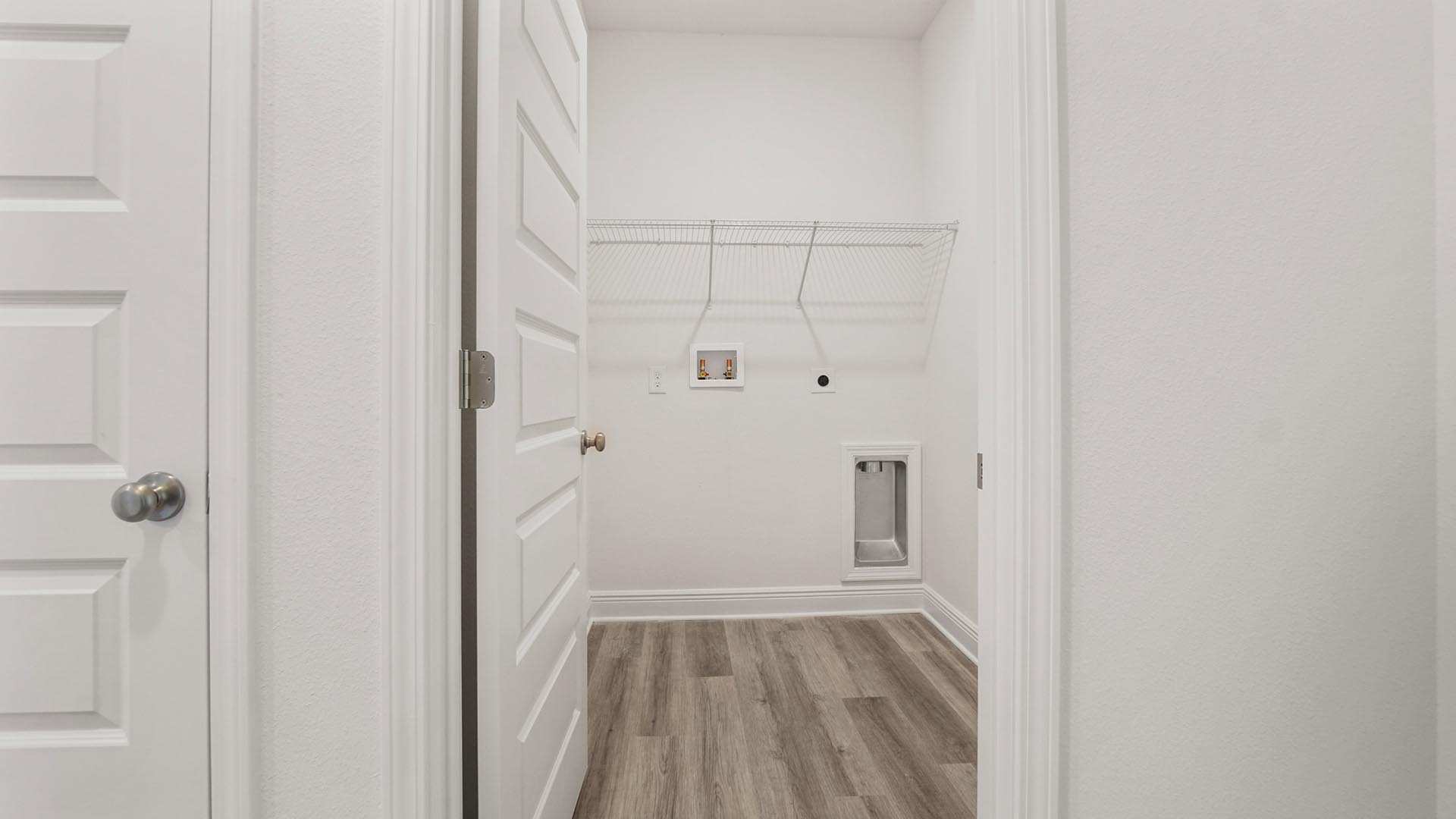 The laundry room has space for a full size washer and dryer