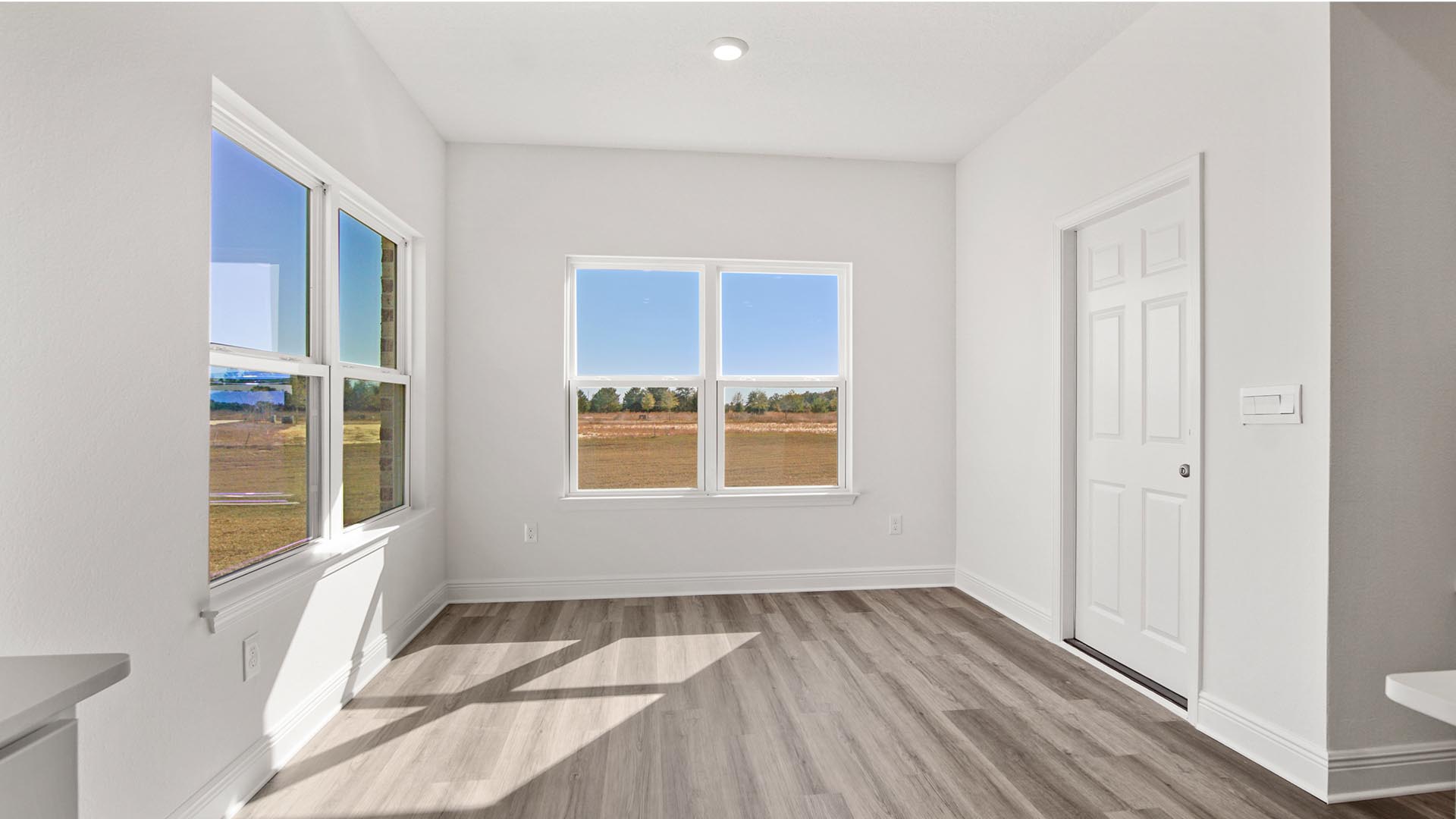 There is a dining area adjacent to the kitchen that overlooks the back lawn