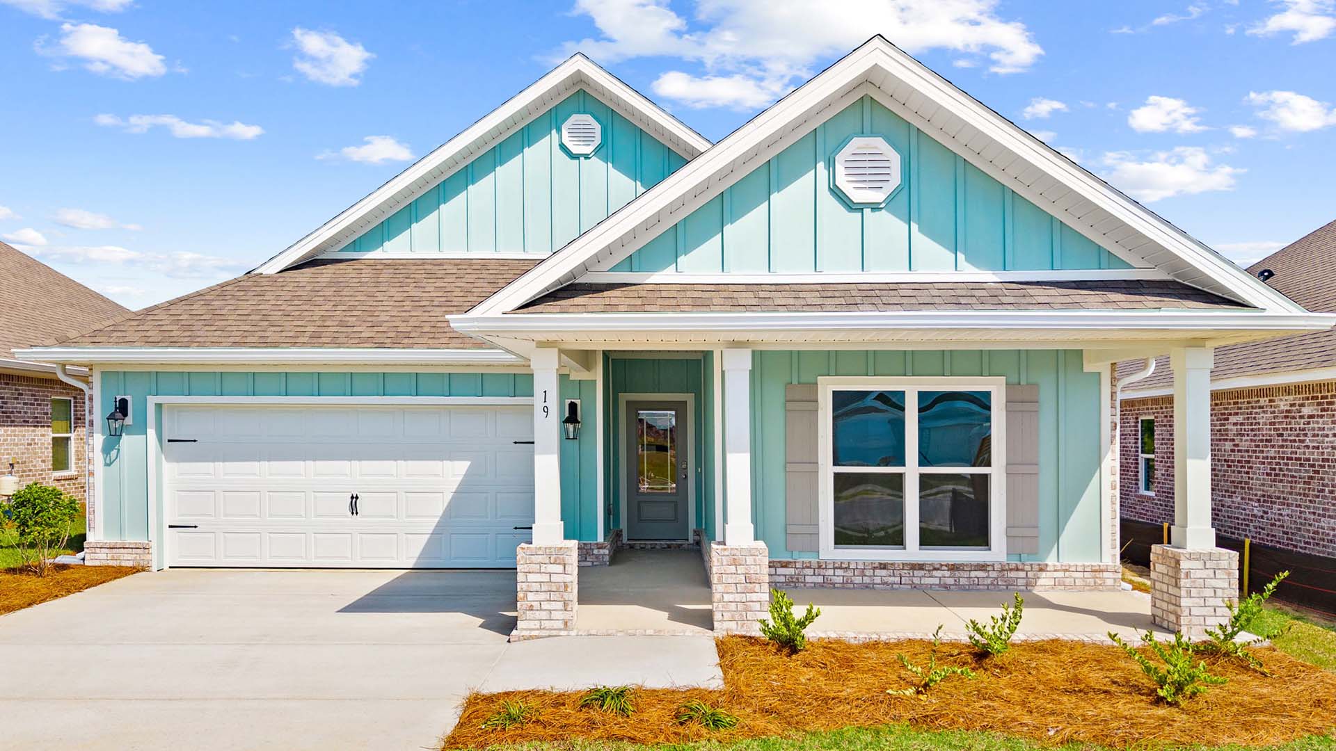 The Riverside floor plan has five bedrooms and a covered front porch with a two car garage