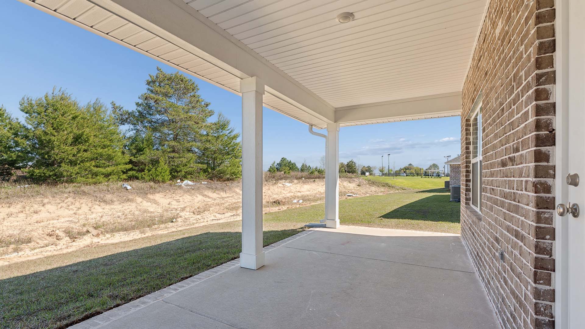The covered back patio has space for seating and a dining table