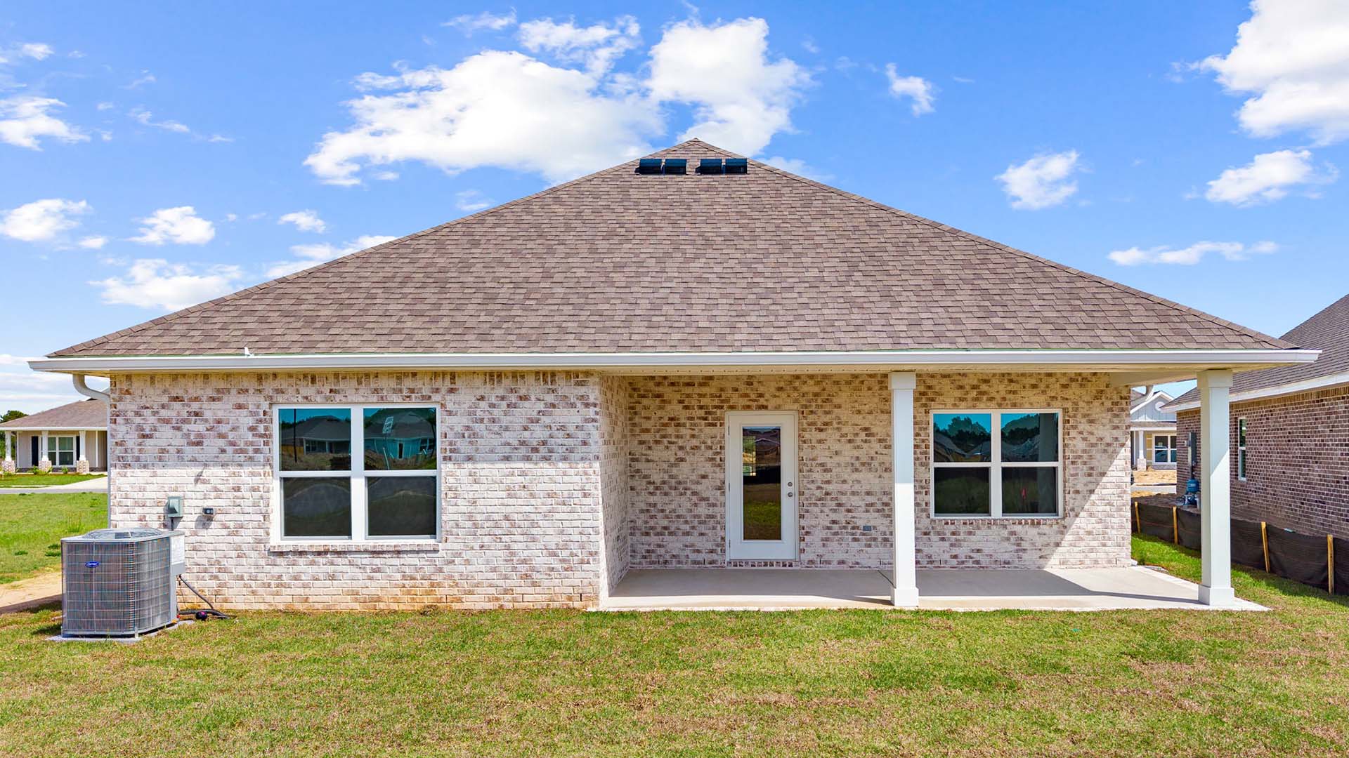 The back of the home has a covered patio
