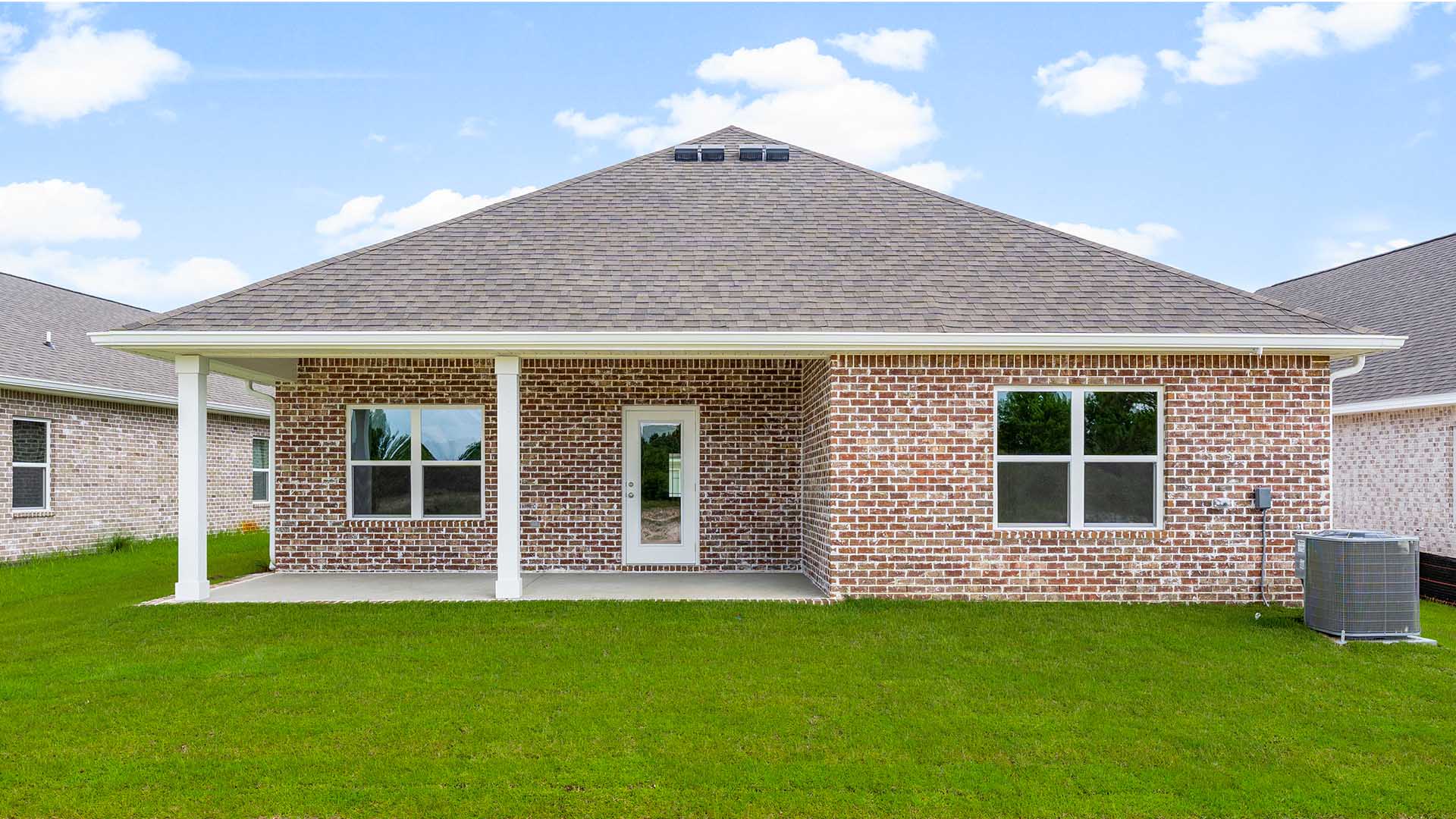Covered patio at the back of the home. This home has three sides full brick and front exterior with Hardie and a brick skirt.