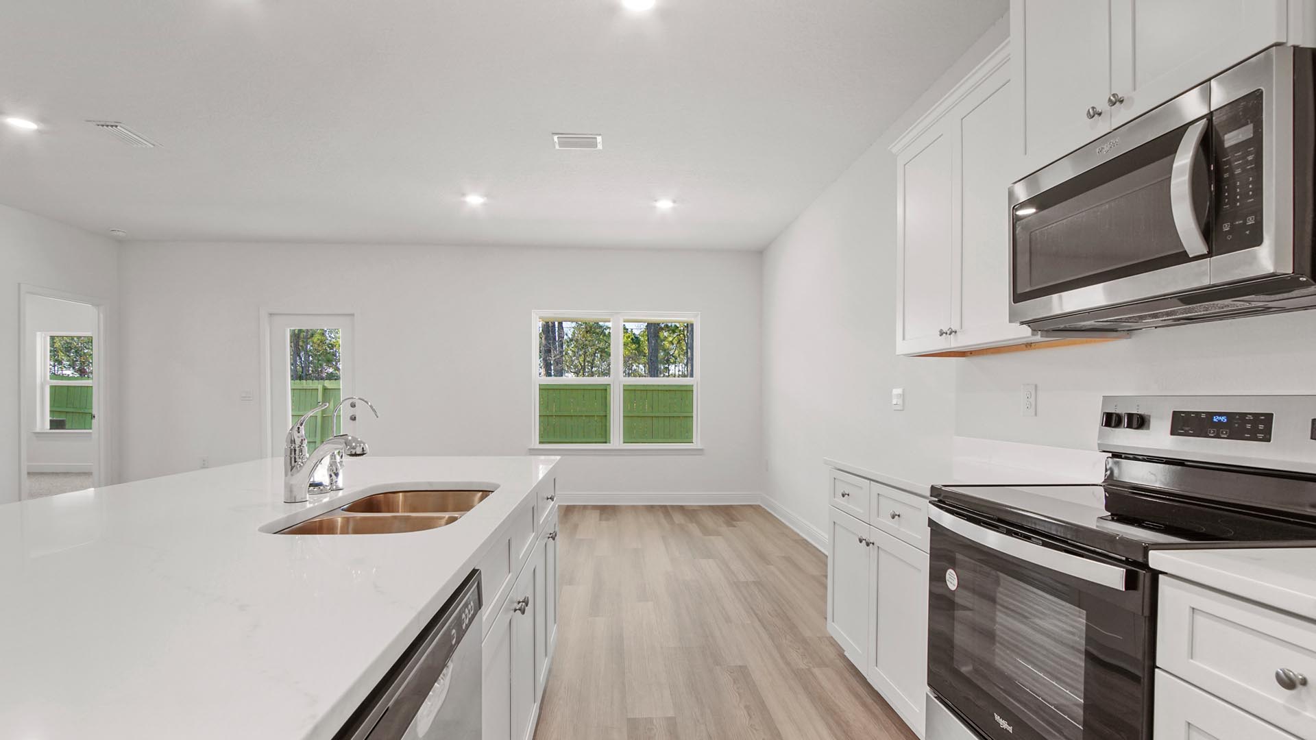 The kitchen features upper and lower cabinetry for storage