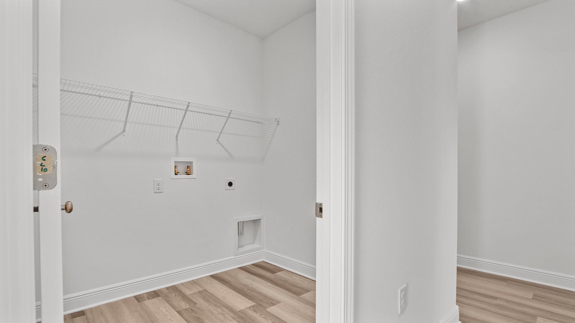 The laundry room has space for a full size washer and dryer
