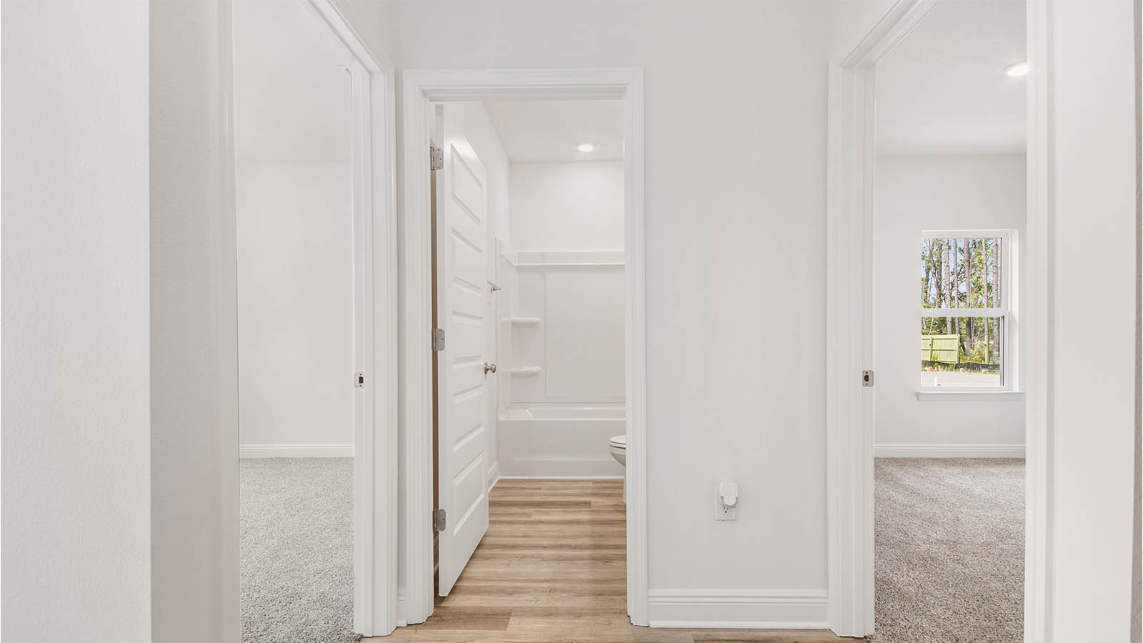 There is a dedicated hall leading to bedroom four, the laundry room and garage access.