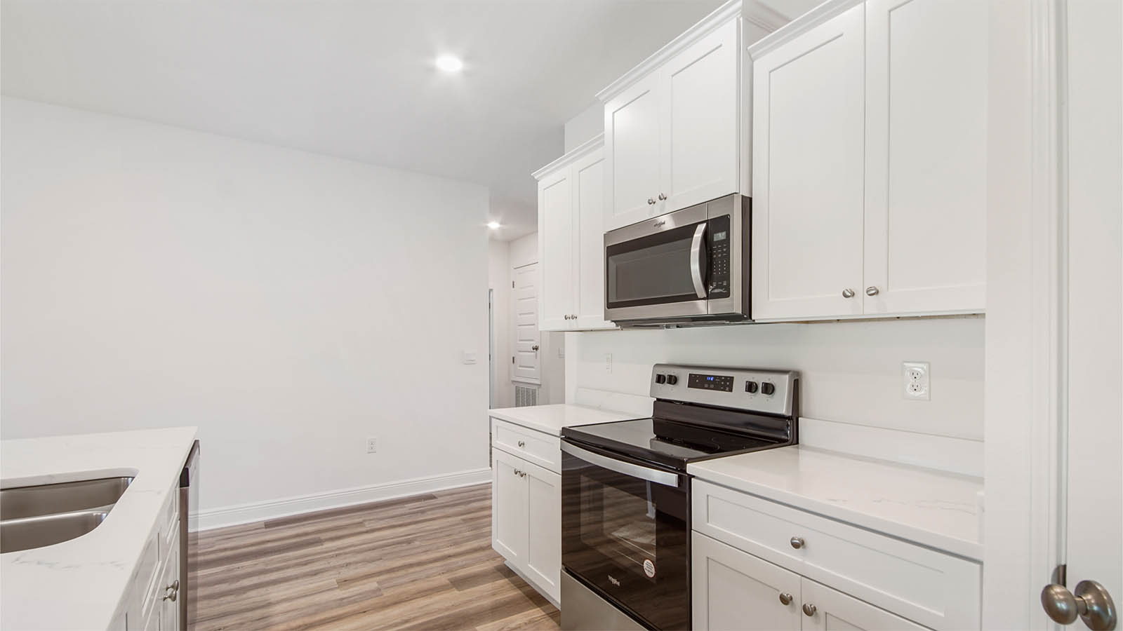 The kitchen has a stainless appliance package including a smooth top stove, microwave and dishwasher