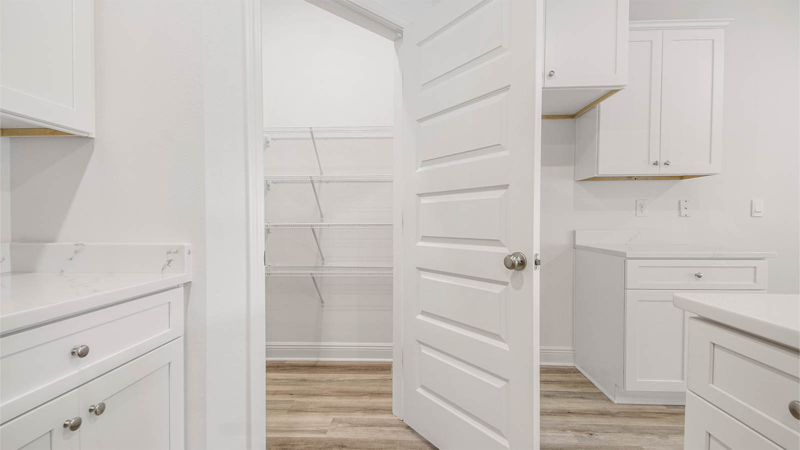 The kitchen has a large corner pantry with shelving for storage