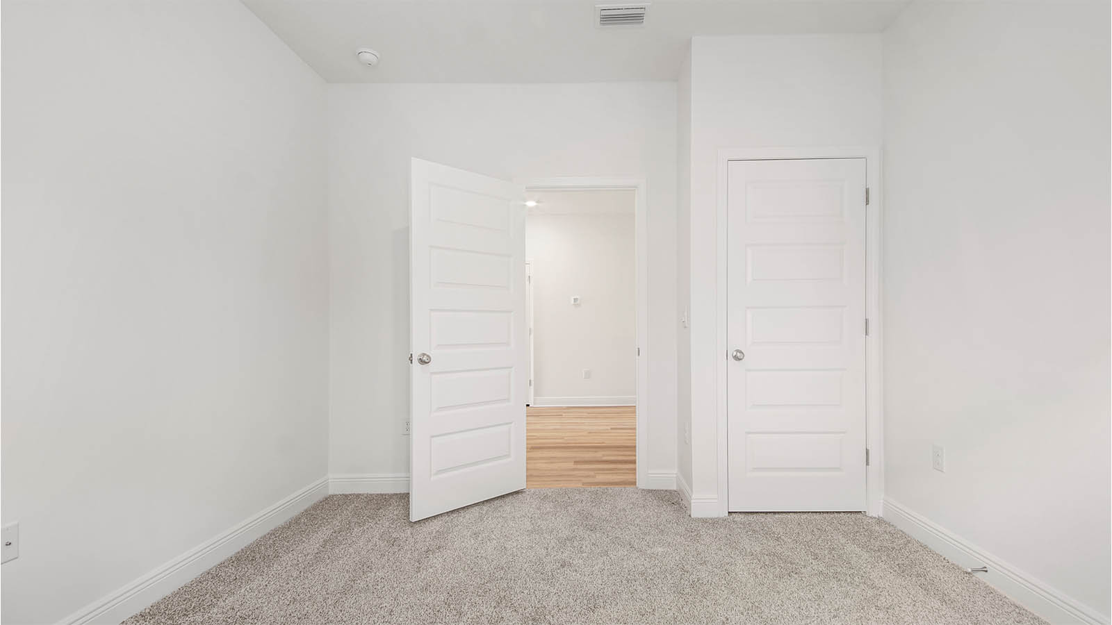 Bedroom four has carpet and a spacious closet