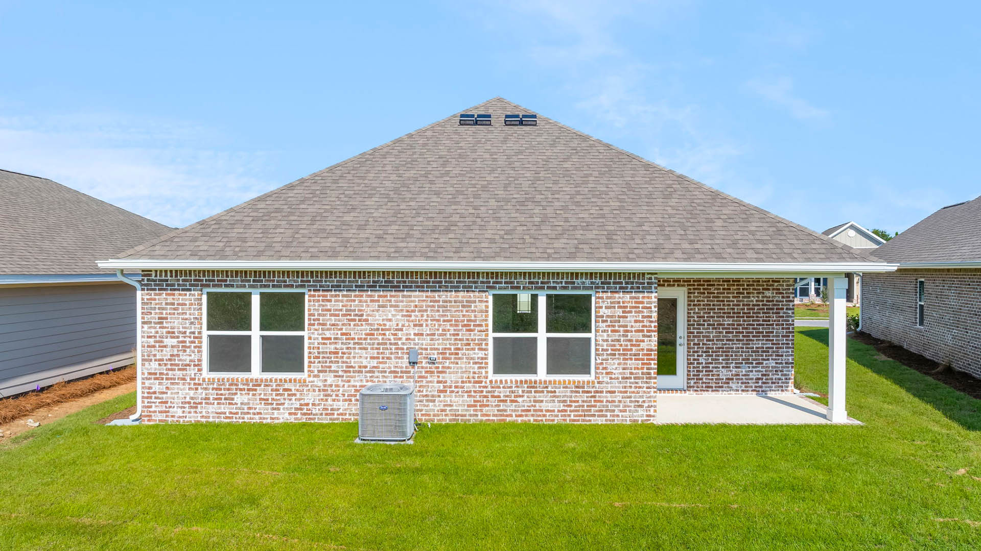 The back of the Rhett has brick siding and a covered patio