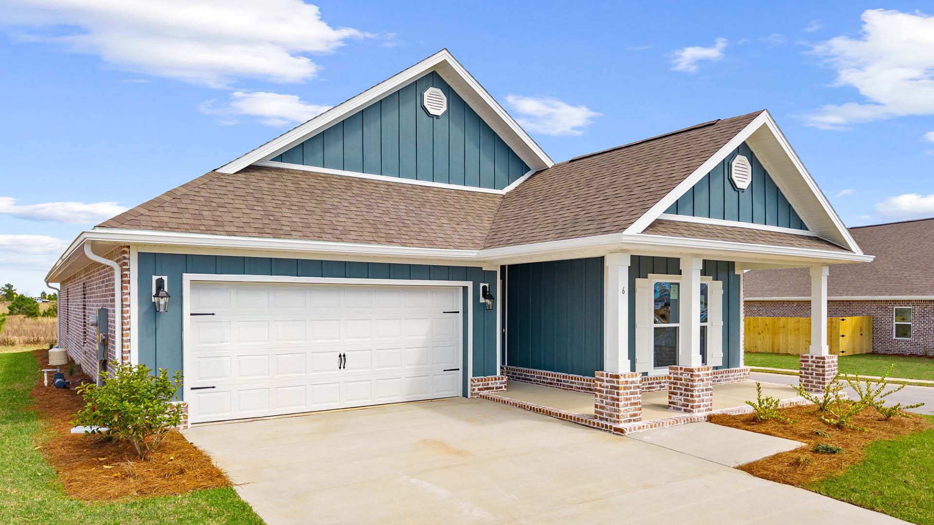 This home has a two car garage and the front exterior is combination of Hardie siding with a brick skirt