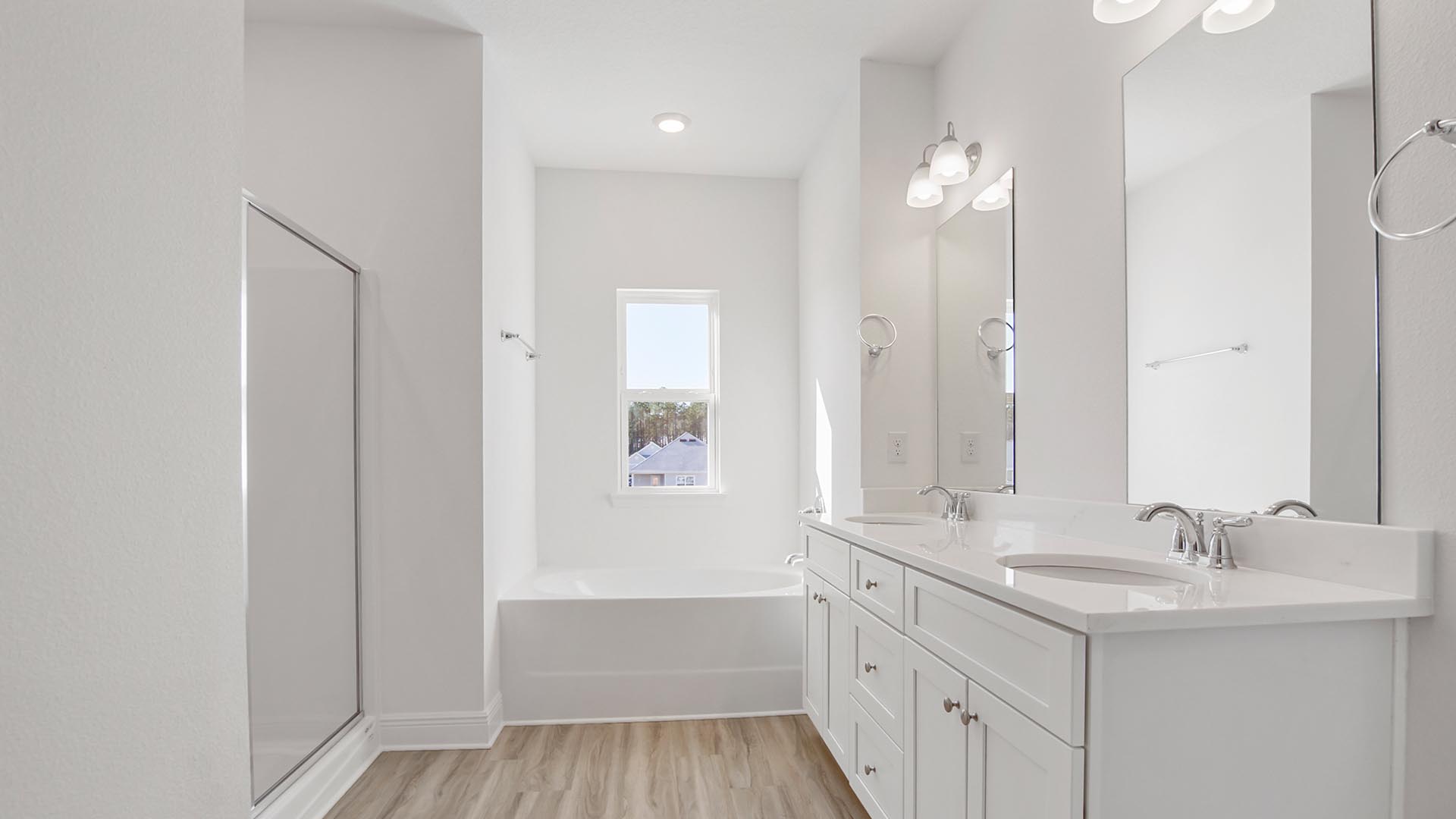 The primary bathroom has a dual sink vanity with quartz countertops