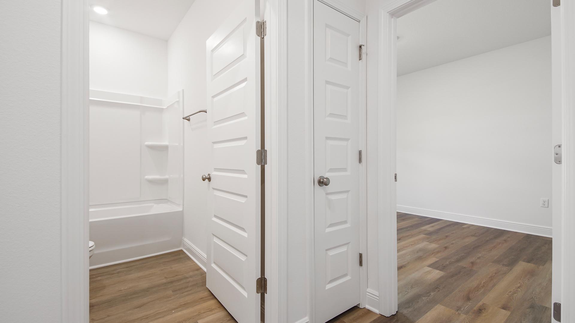 Hall leading to bedrooms two and three with shared bathroom