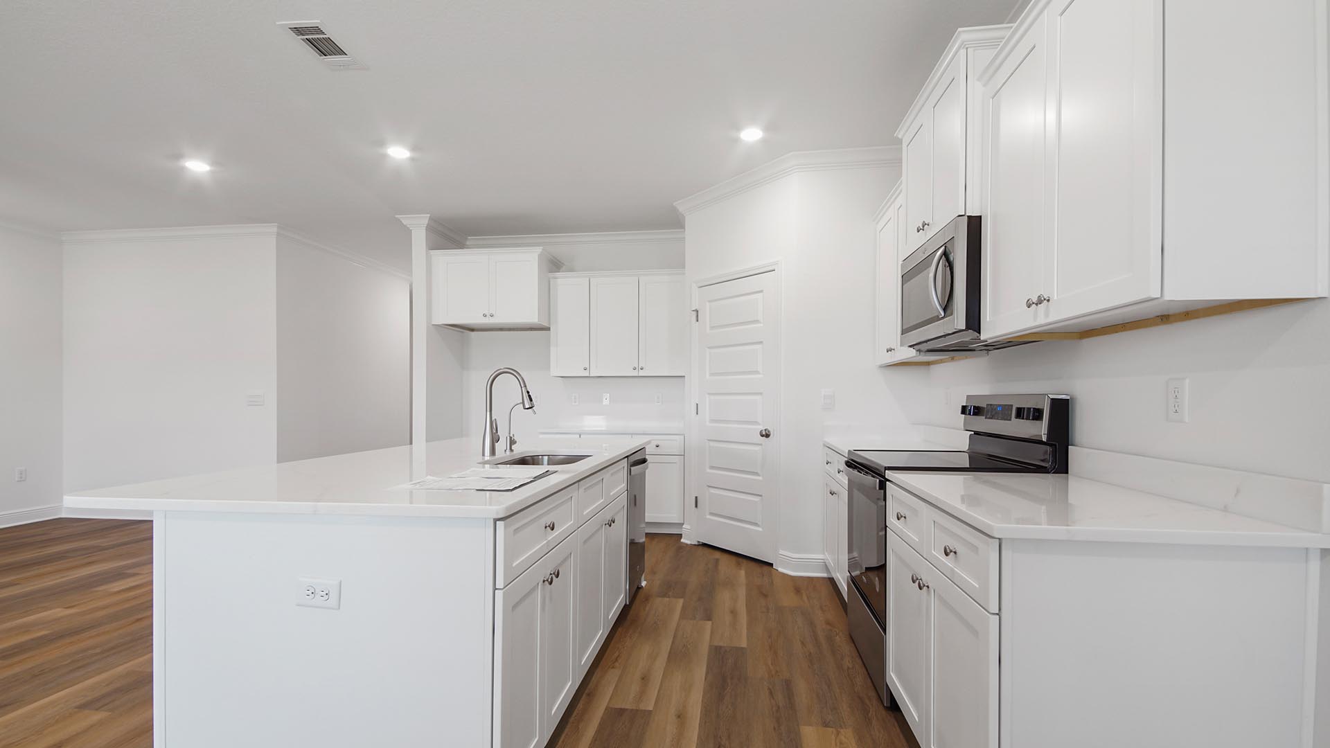 The center island has a stainless sink and dishwasher for easy prep and clean up