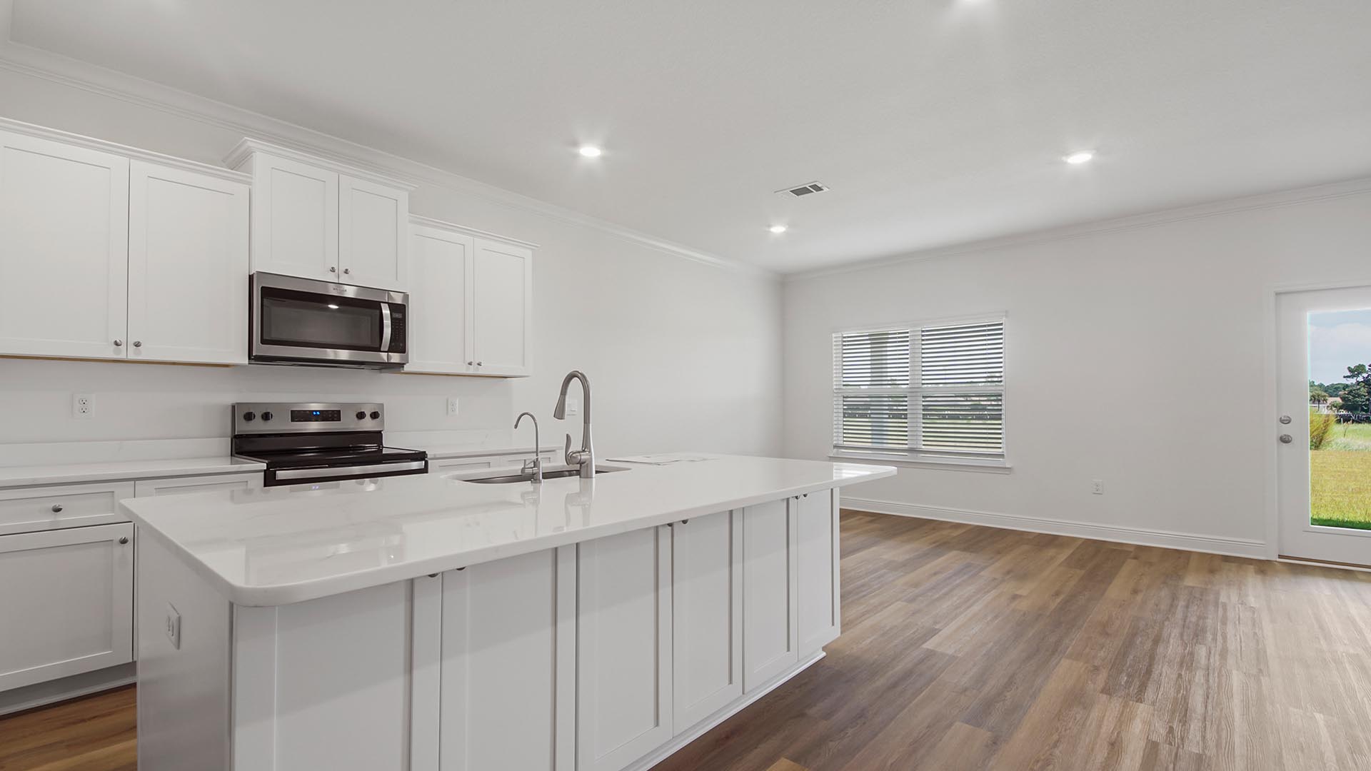 The kitchen features a center island and quartz countertops