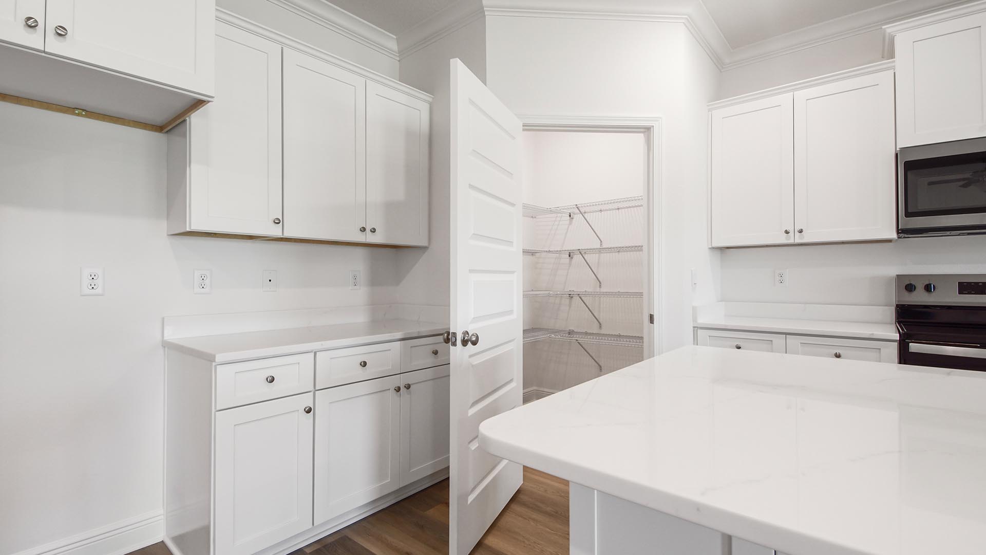 The kitchen has a large pantry with plenty of storage space