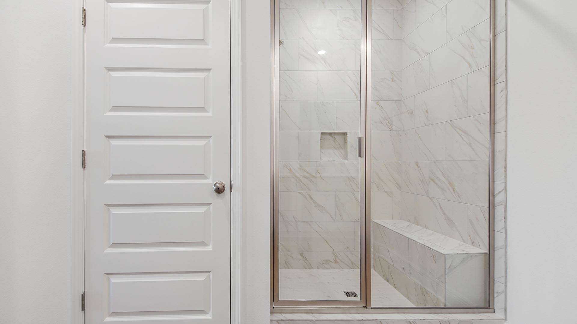 The primary bathroom features a shower with glass enclosure