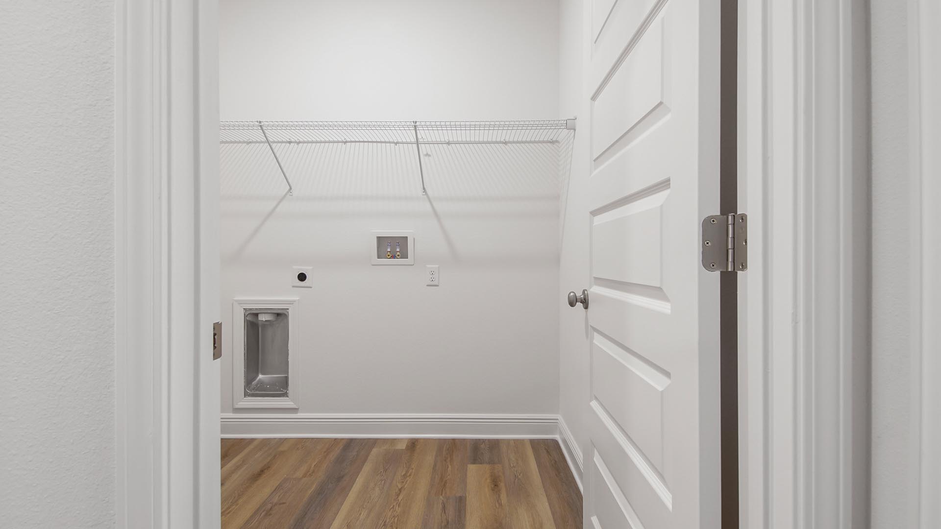 The Delray has a large laundry room with EVP floors and space for a full size washer and dryer