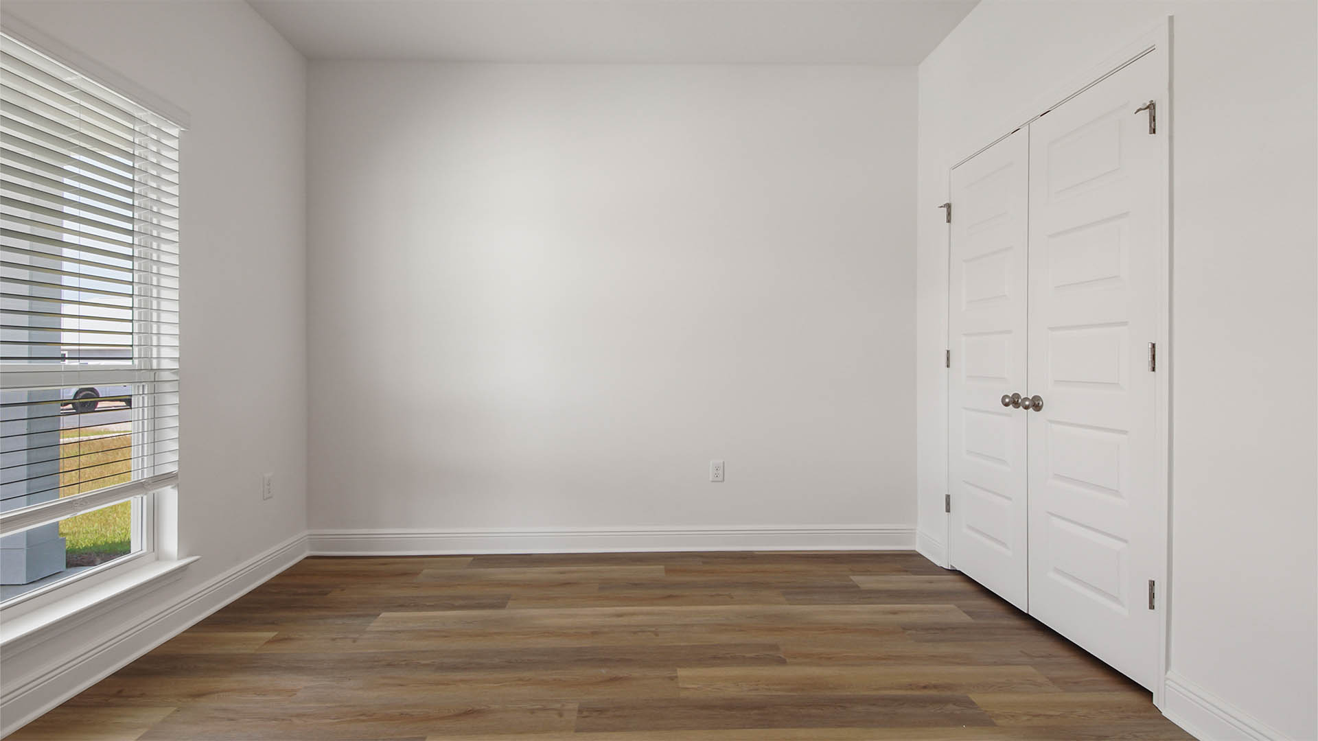 Bedroom three with EVP flooring and large window and closet.