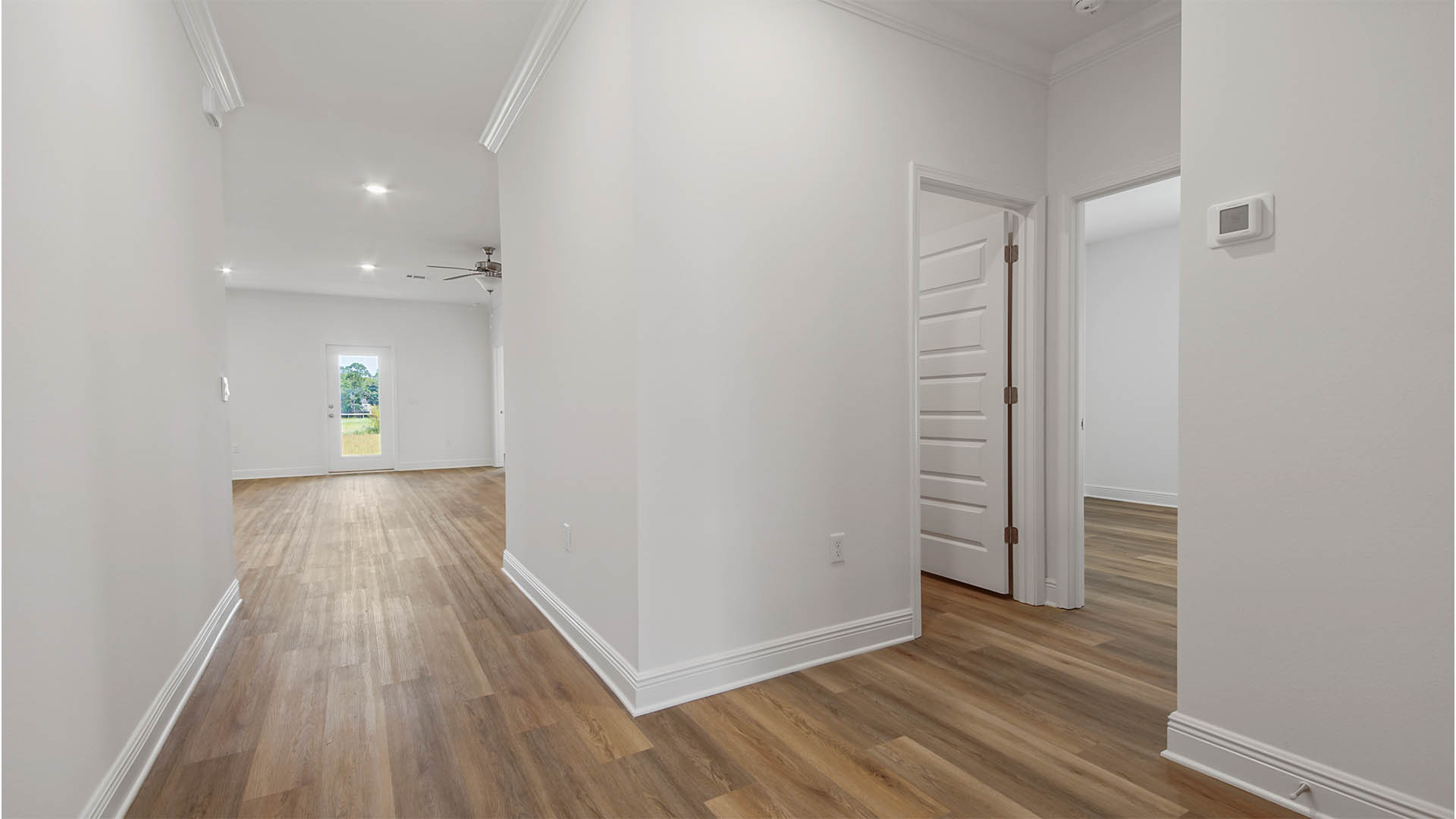 Hallway by bedroom and laundry room and garage with EVP flooring.