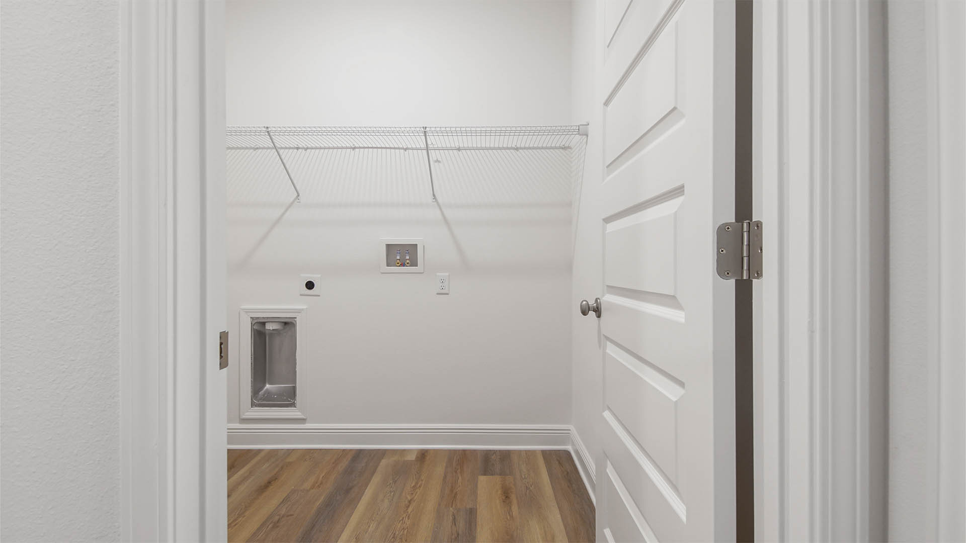 Laundry room with EVP flooring and ventilated shelving.