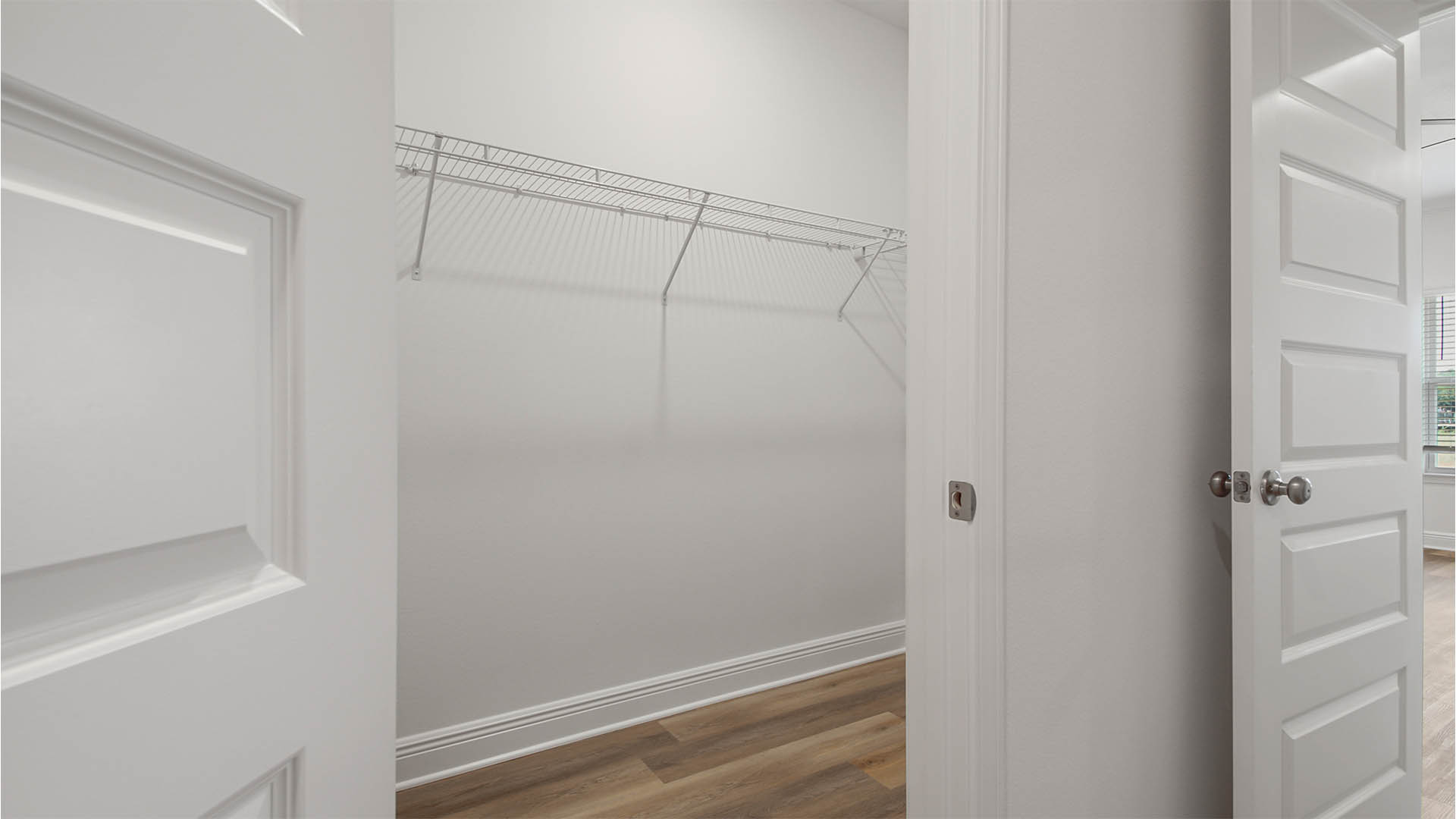 Primary bathroom with EVP flooring and walk in closet.