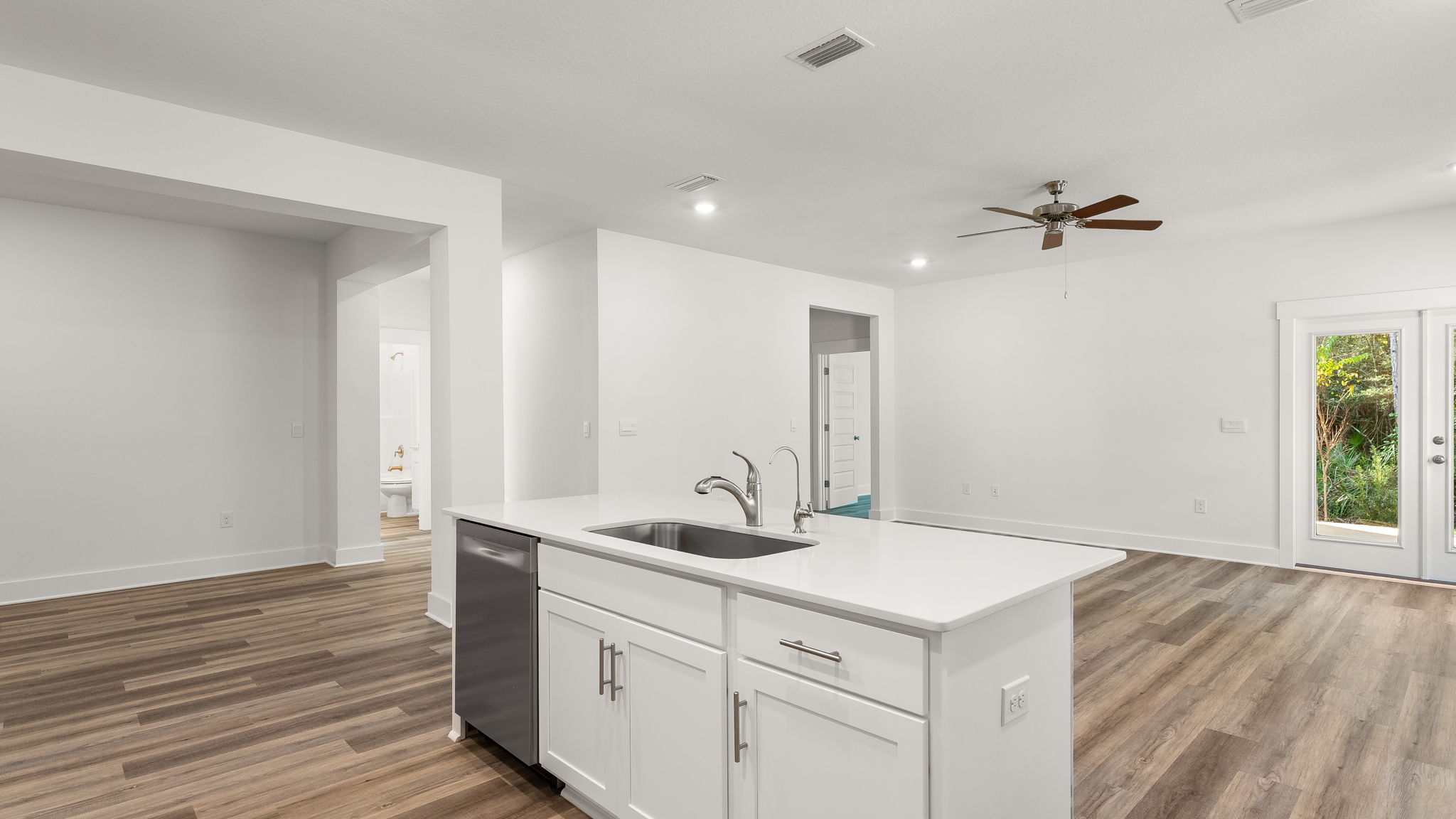 The center island holds the sink and dishwasher for easy meal prep and clean up