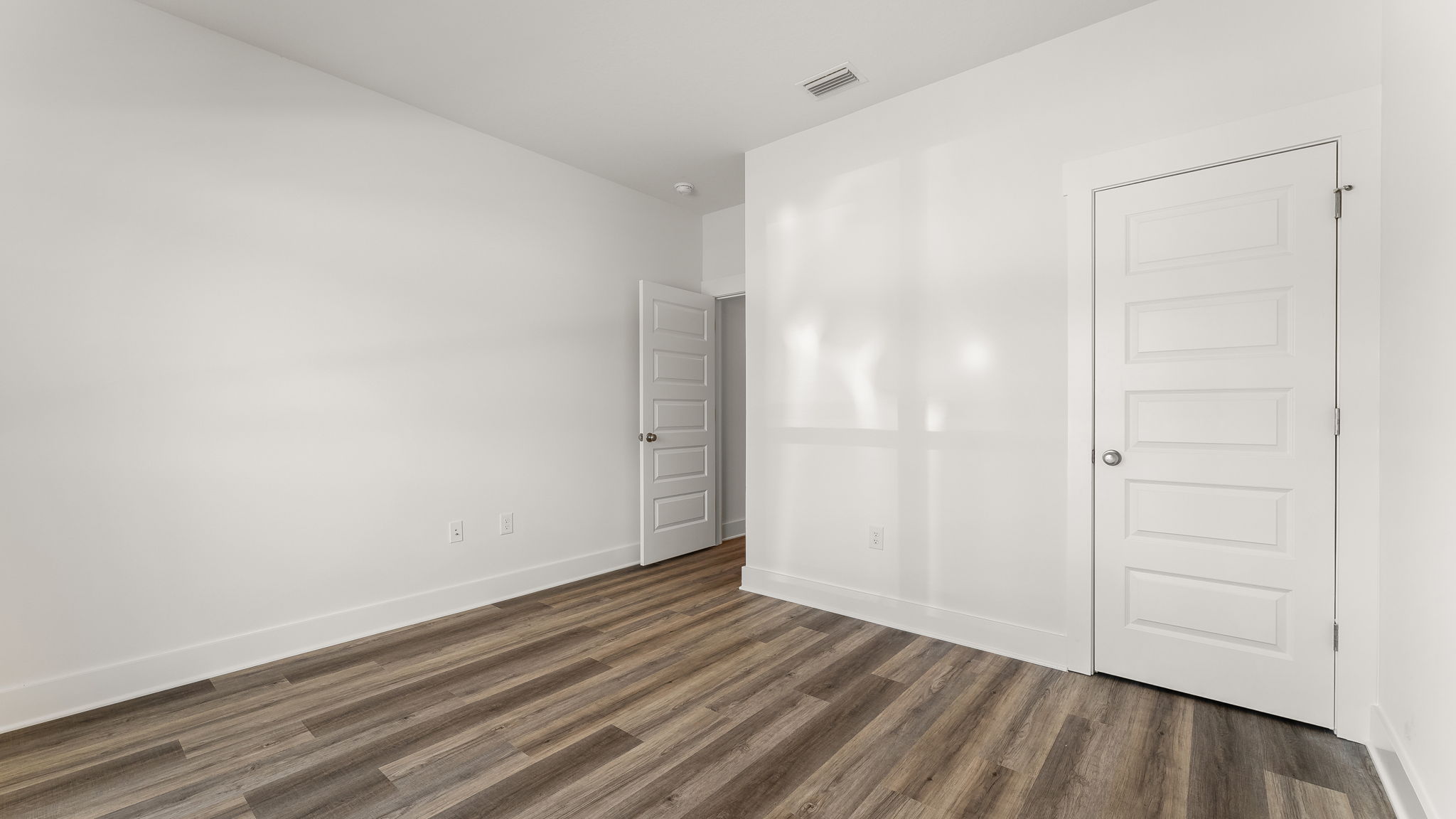 Guest bedroom three has EVP flooring and ample closet space