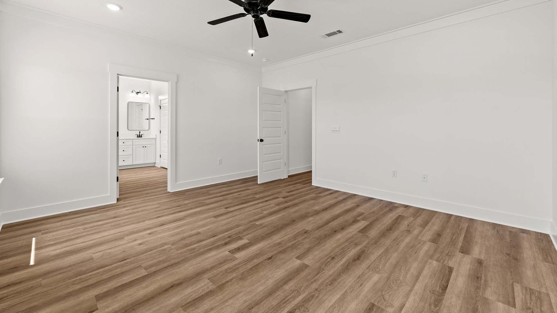 The primary bedroom has a ceiling fan