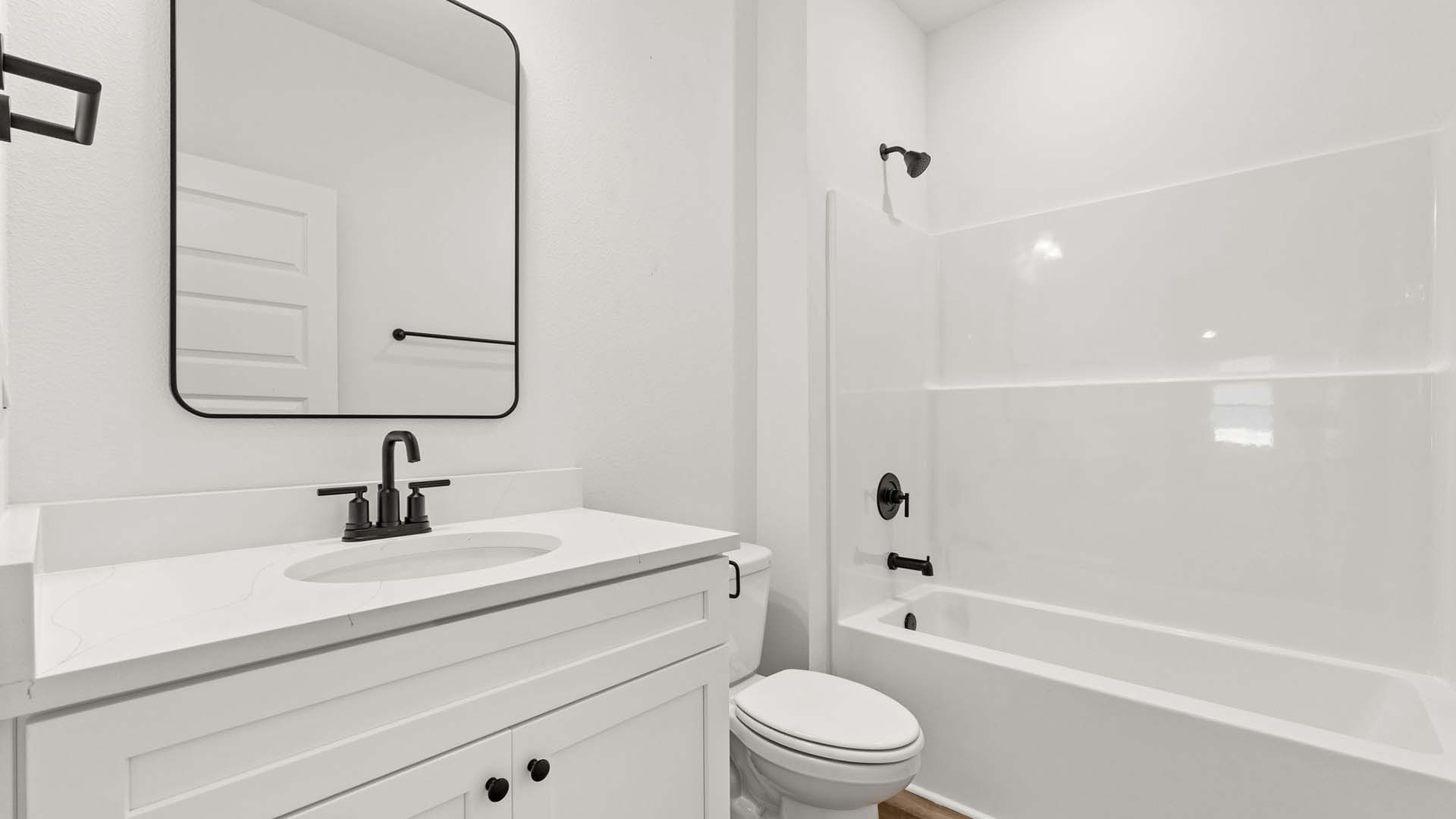 Two guest bedrooms share a full bath with shower tub combination