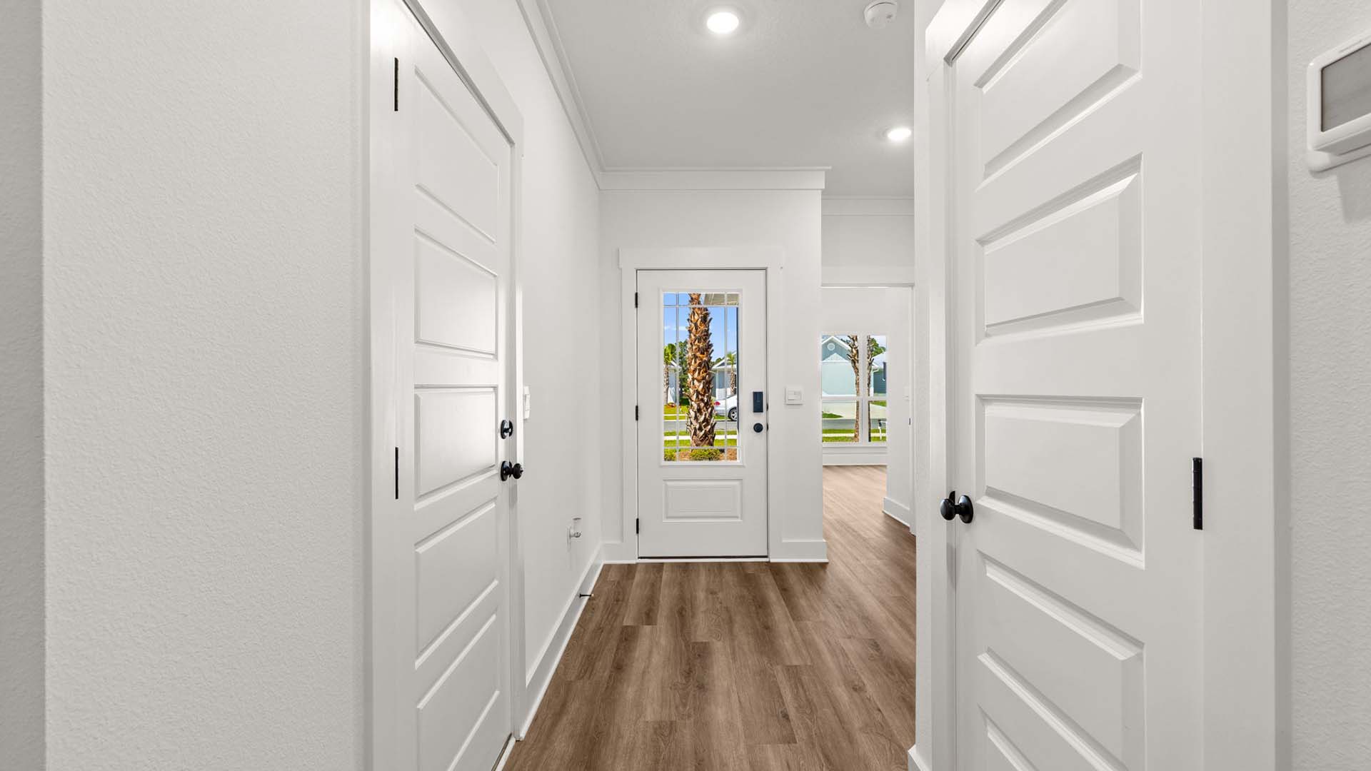 Entry hall leading back to bedrooms three and four off the front entry