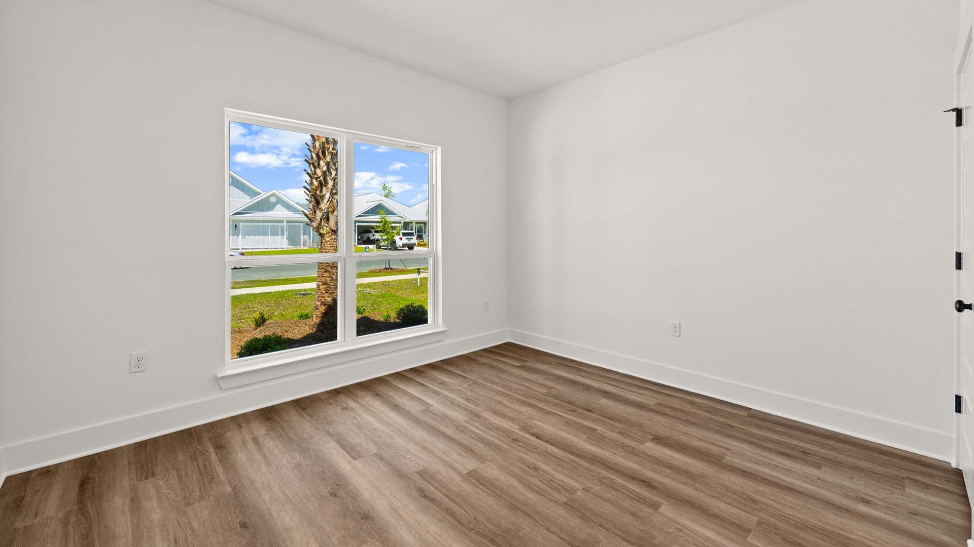 Guest bedroom three is at the front of the home with a large picture window